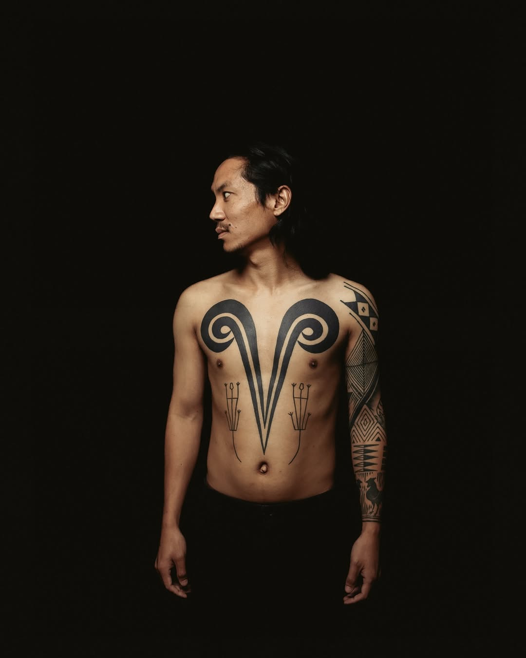Tribal chest spiral handpoke by Mo Naga