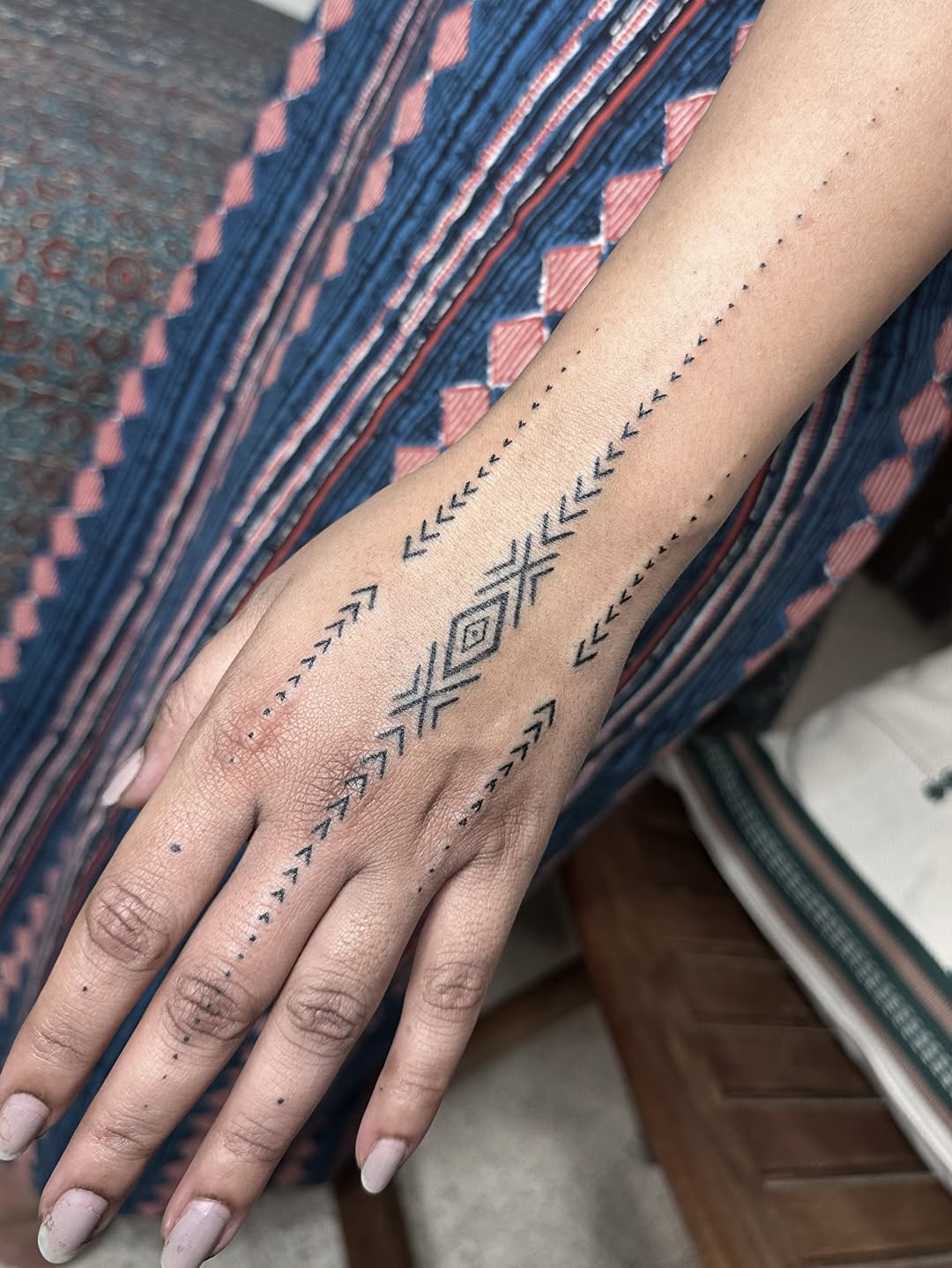 Handpoke geometric hand tattoo by Mo Naga