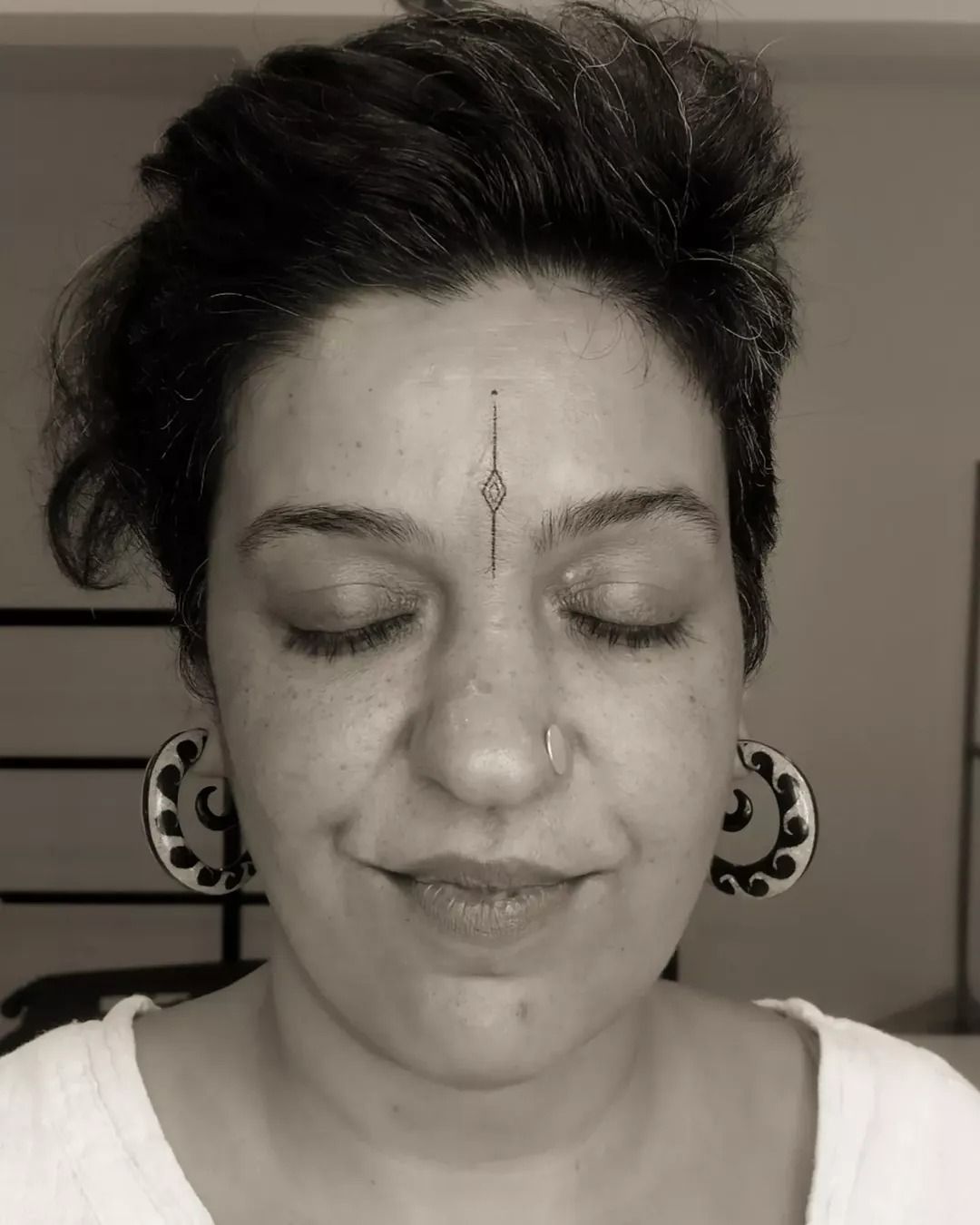 Forehead diamond handpoke tattoo by Mo Naga