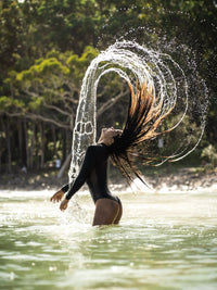 side view of woman wearing a Black Long Sleeve Swimsuit | The Sulawesi Midnight 