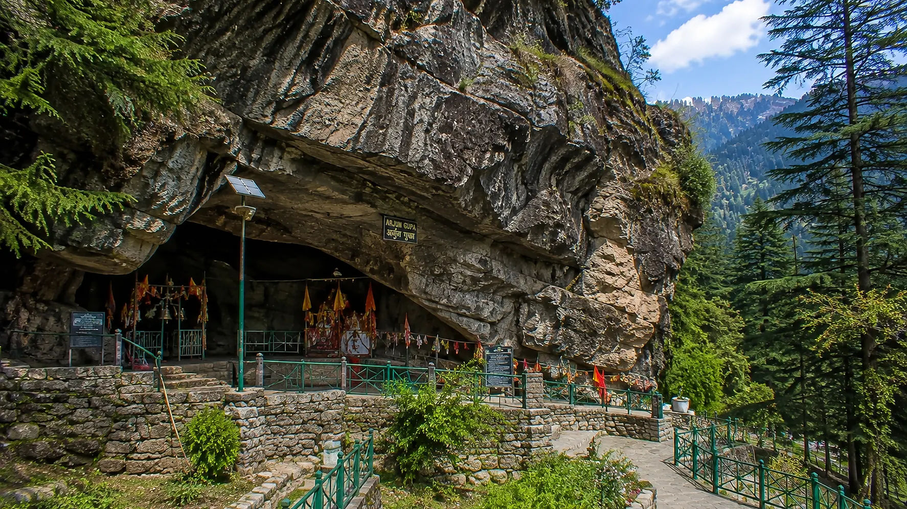 Arjun Gufa cave surrounded by Himalayan forests near Manali