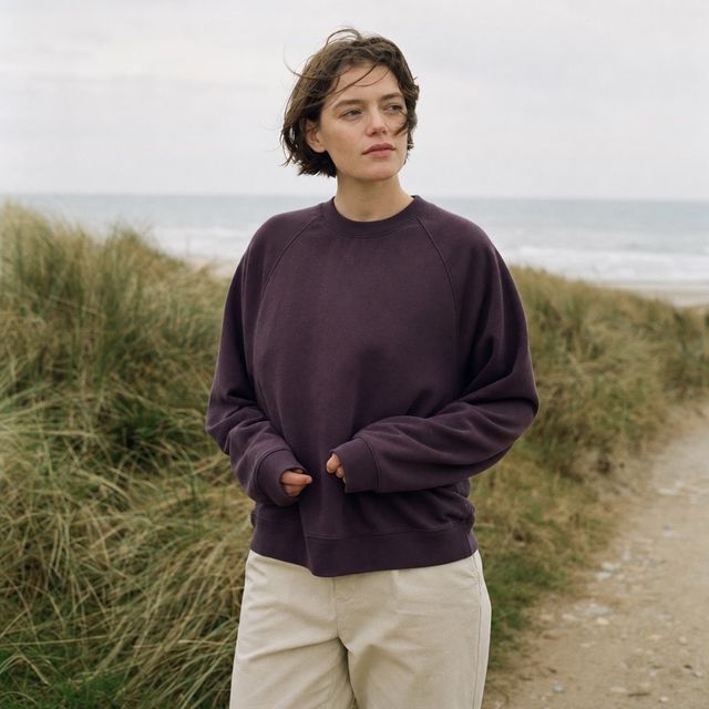 Aubergine loopback sweatshirt on a coastal path