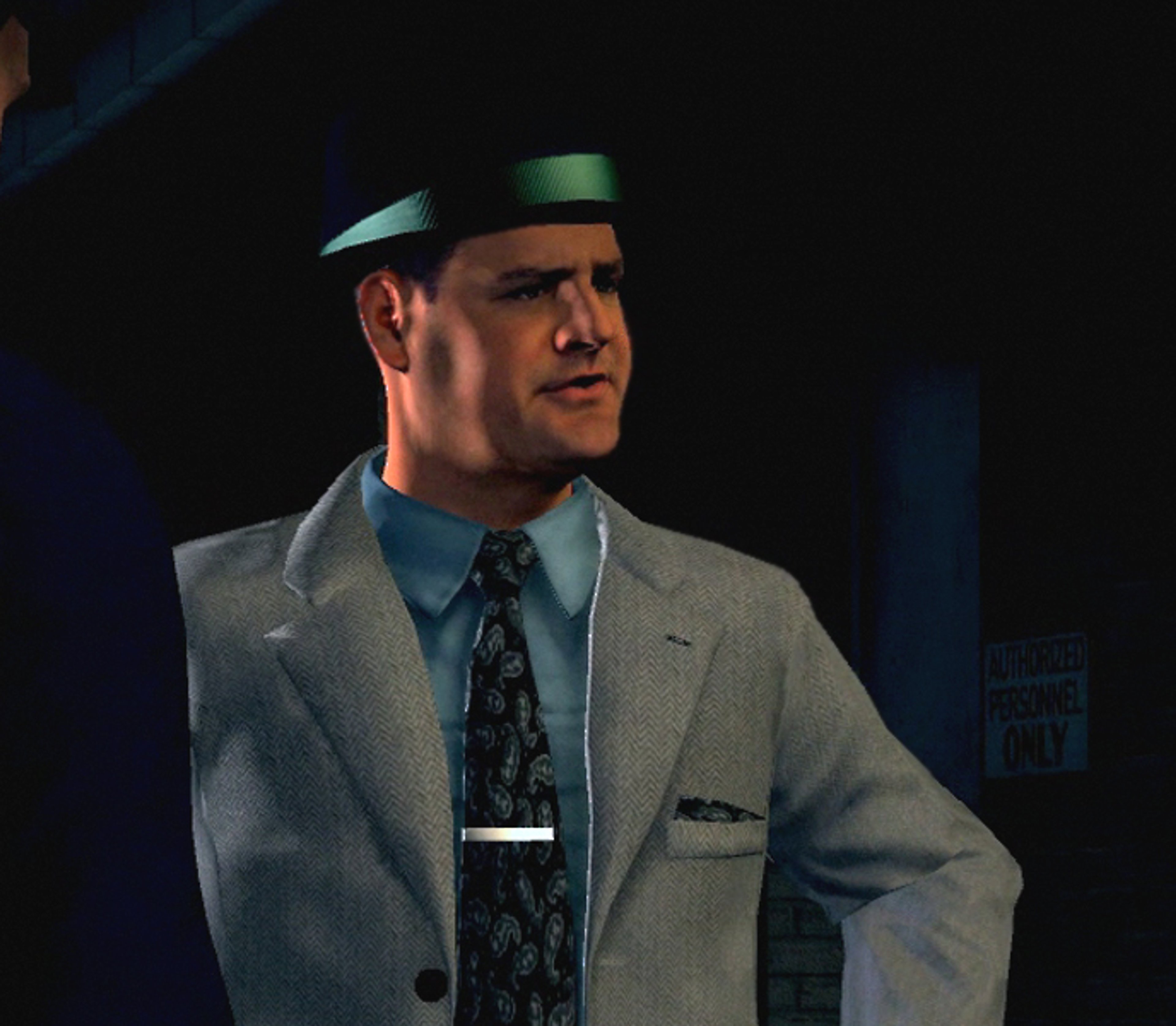 A middle-aged man in a suit and tie, with a serious expression on his face, appears to be a police detective.