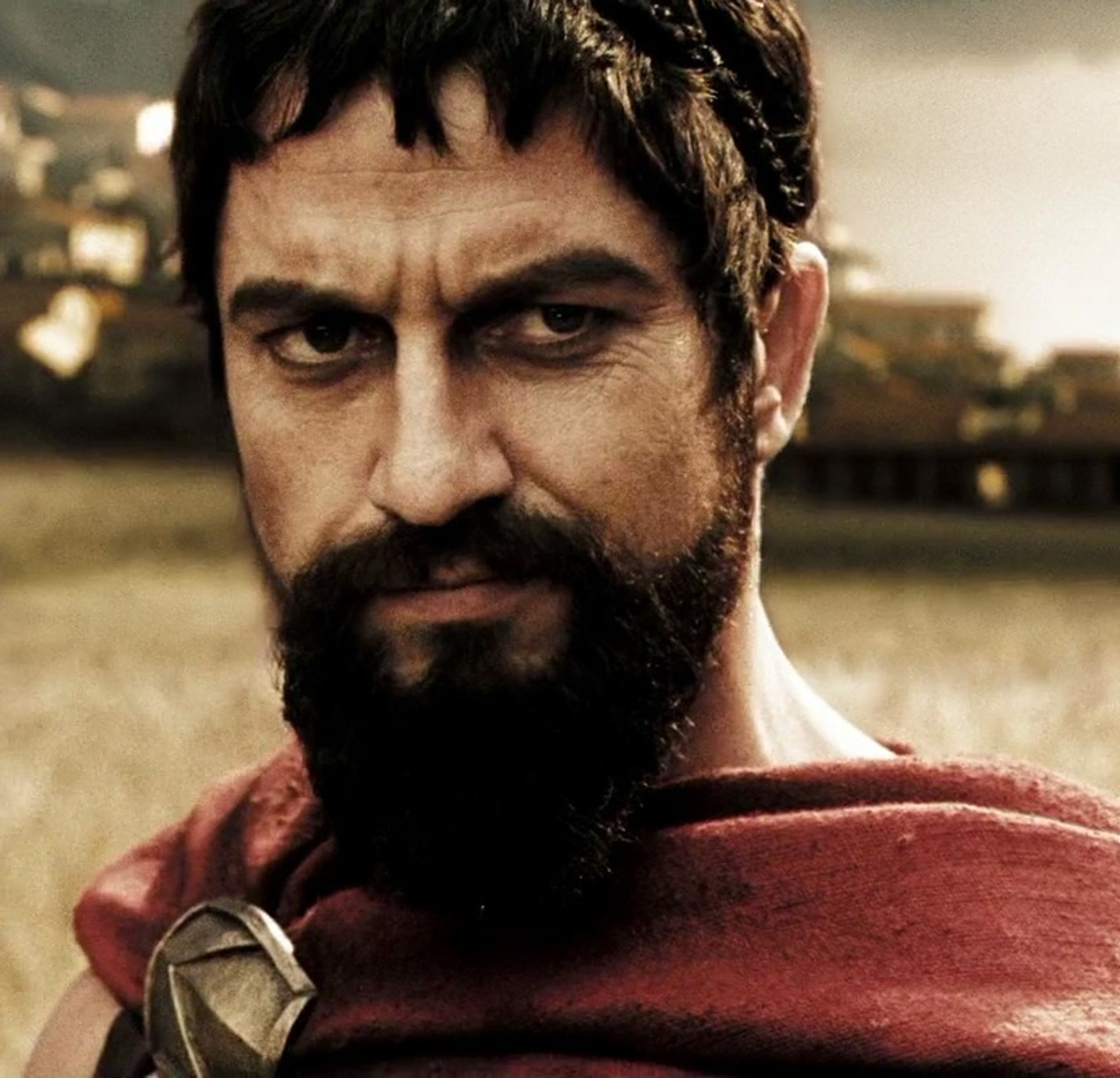 A rugged, bearded warrior in ancient Spartan attire