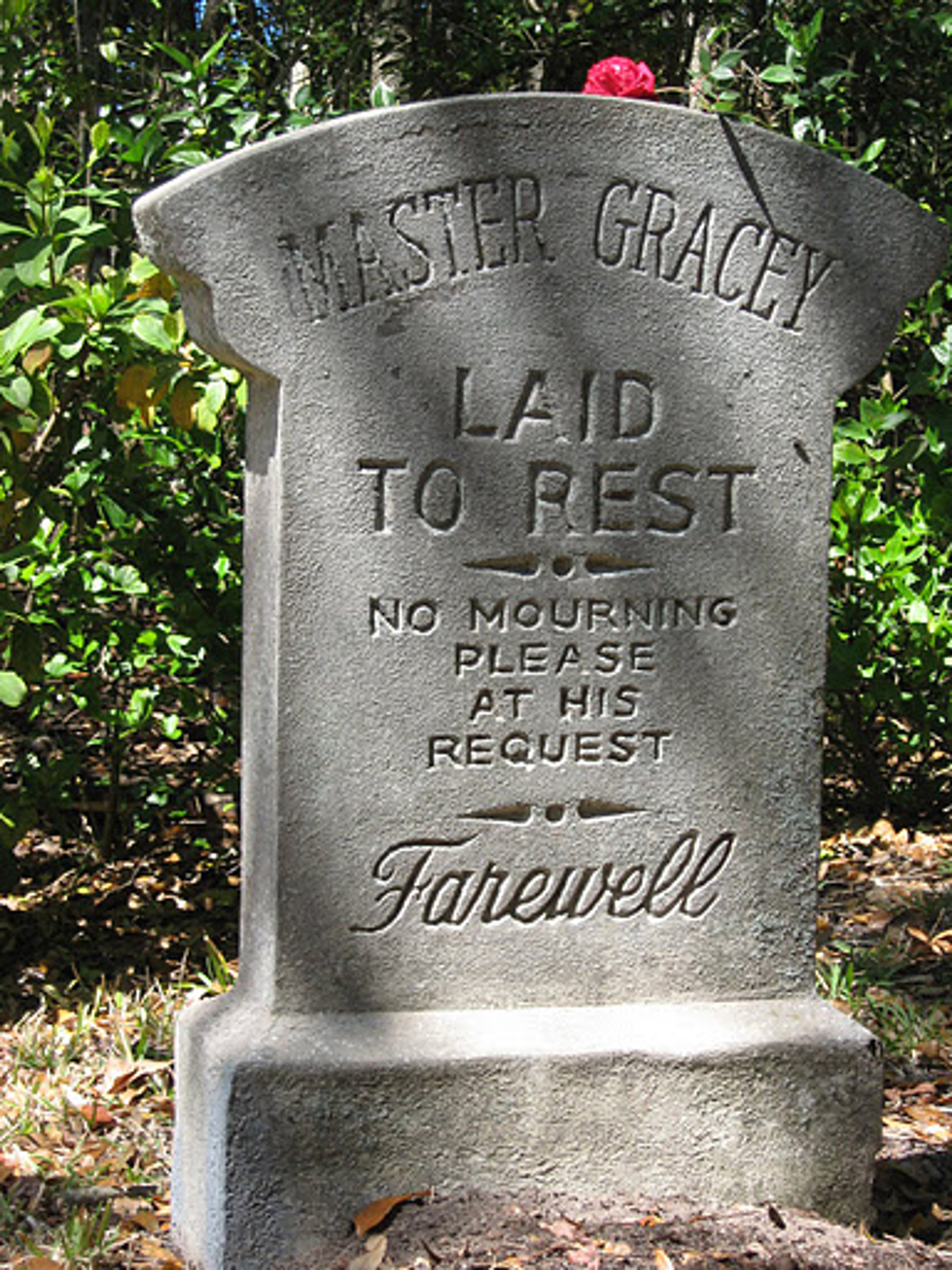 A gravestone with the inscription 'HESTER GRACEY LAID TO REST NO MOURNING PLEASE AT HIS REQUEST FAREWELL'.