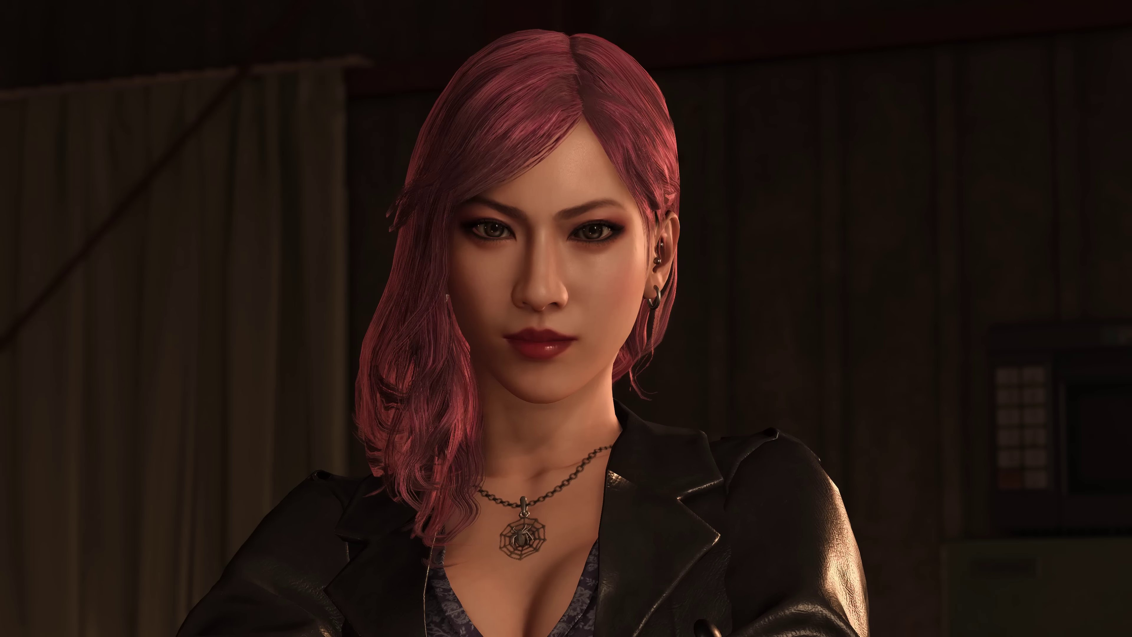 A woman with pink hair wearing a black leather jacket, looking serious and intense.