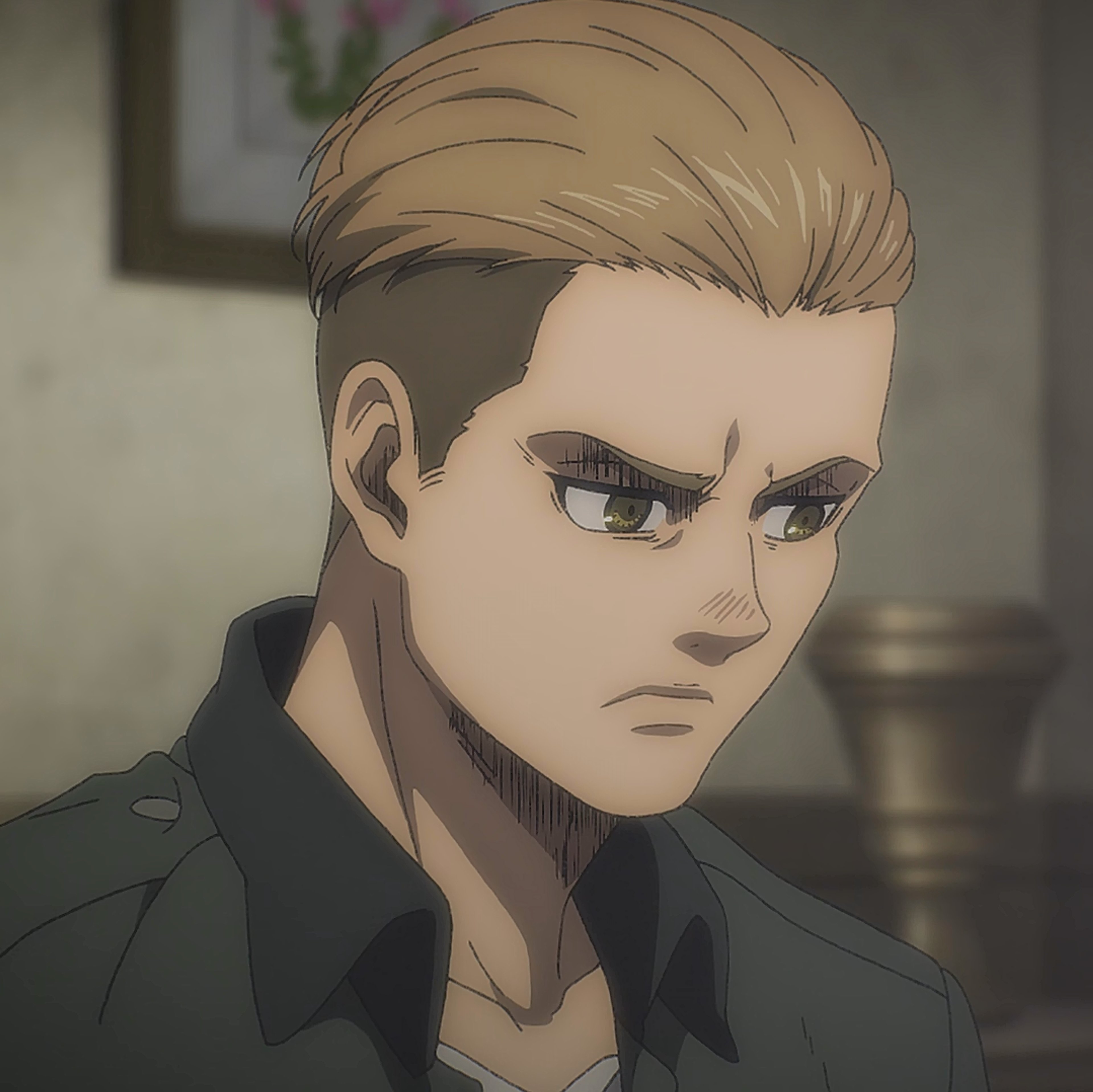 A serious-looking young man with blonde hair and a military uniform