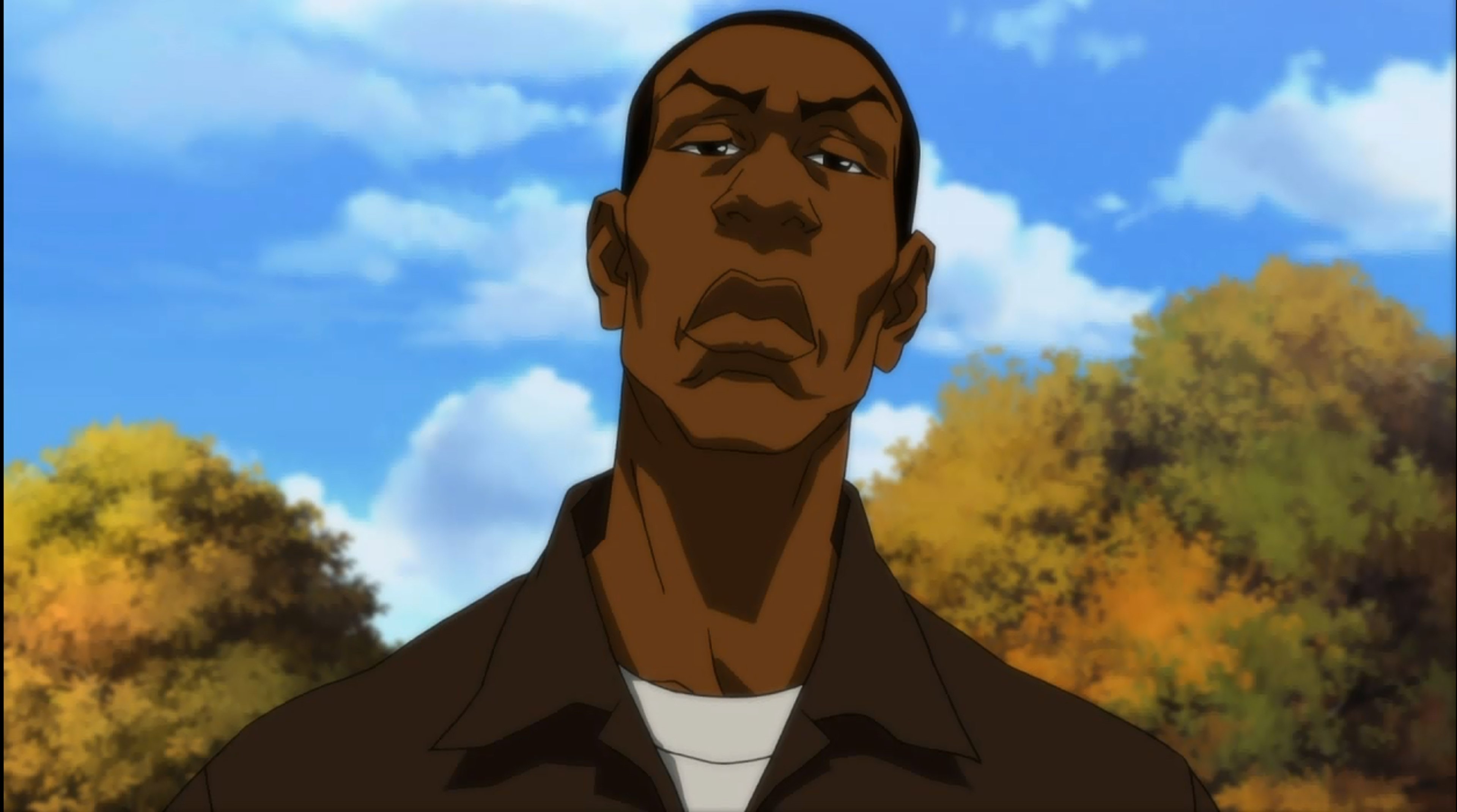 A middle-aged African American man with a serious expression, set against an autumn landscape.