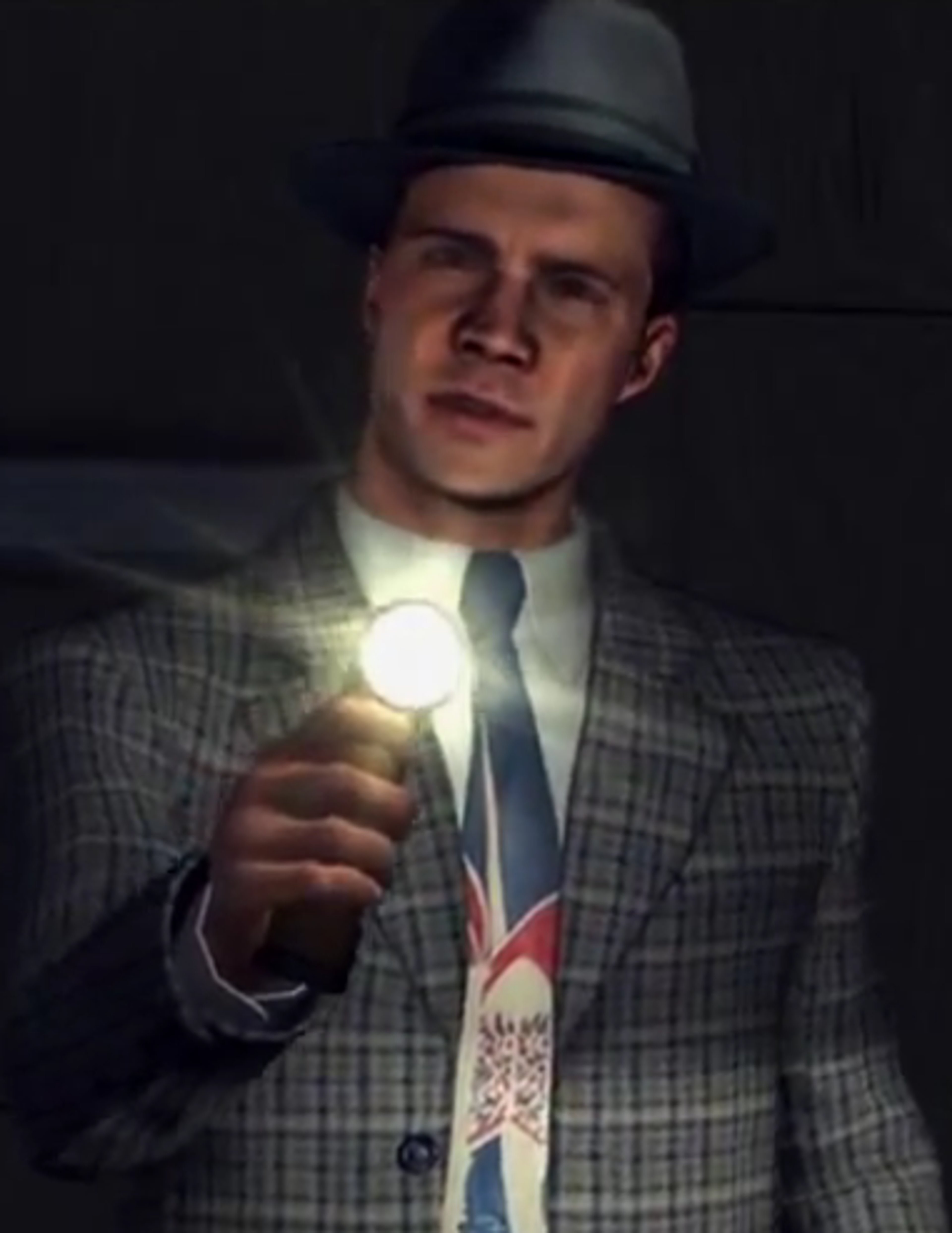 A man in a suit and hat holding an object in a dimly lit setting