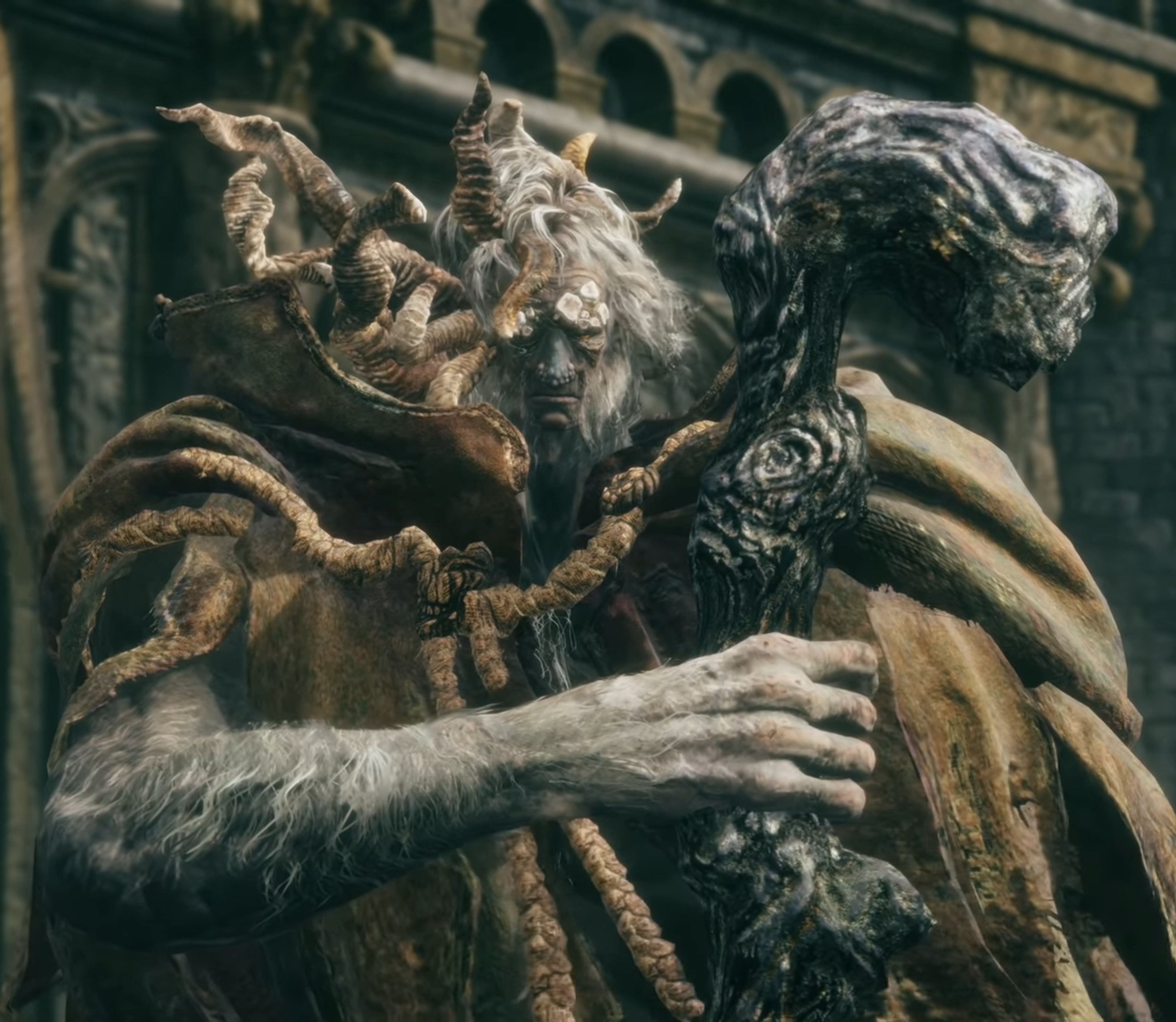 A towering, hunched figure with grayish skin and a crown-like headdress, wielding a spectral staff.