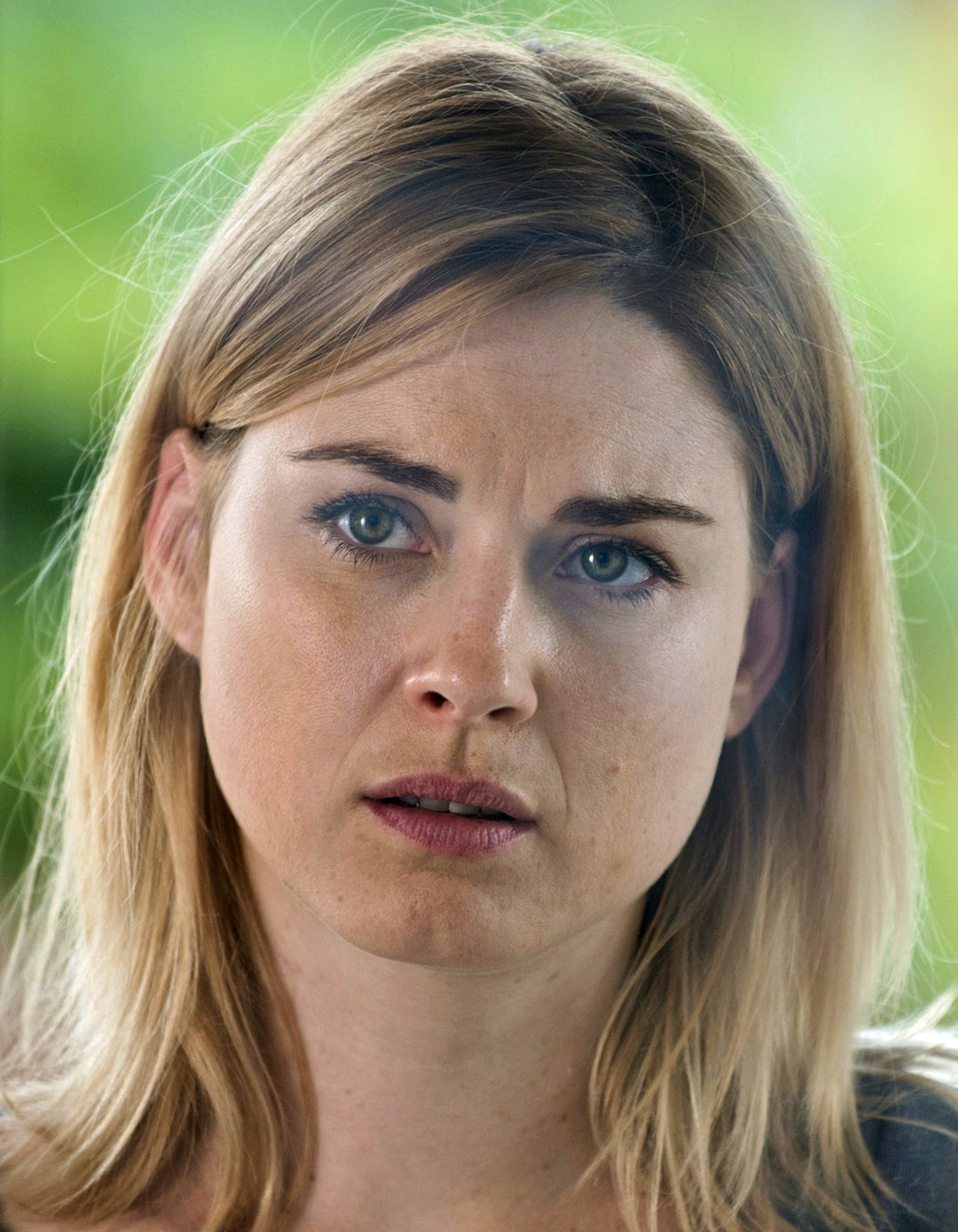 Portrait of a young blonde woman with a serious expression