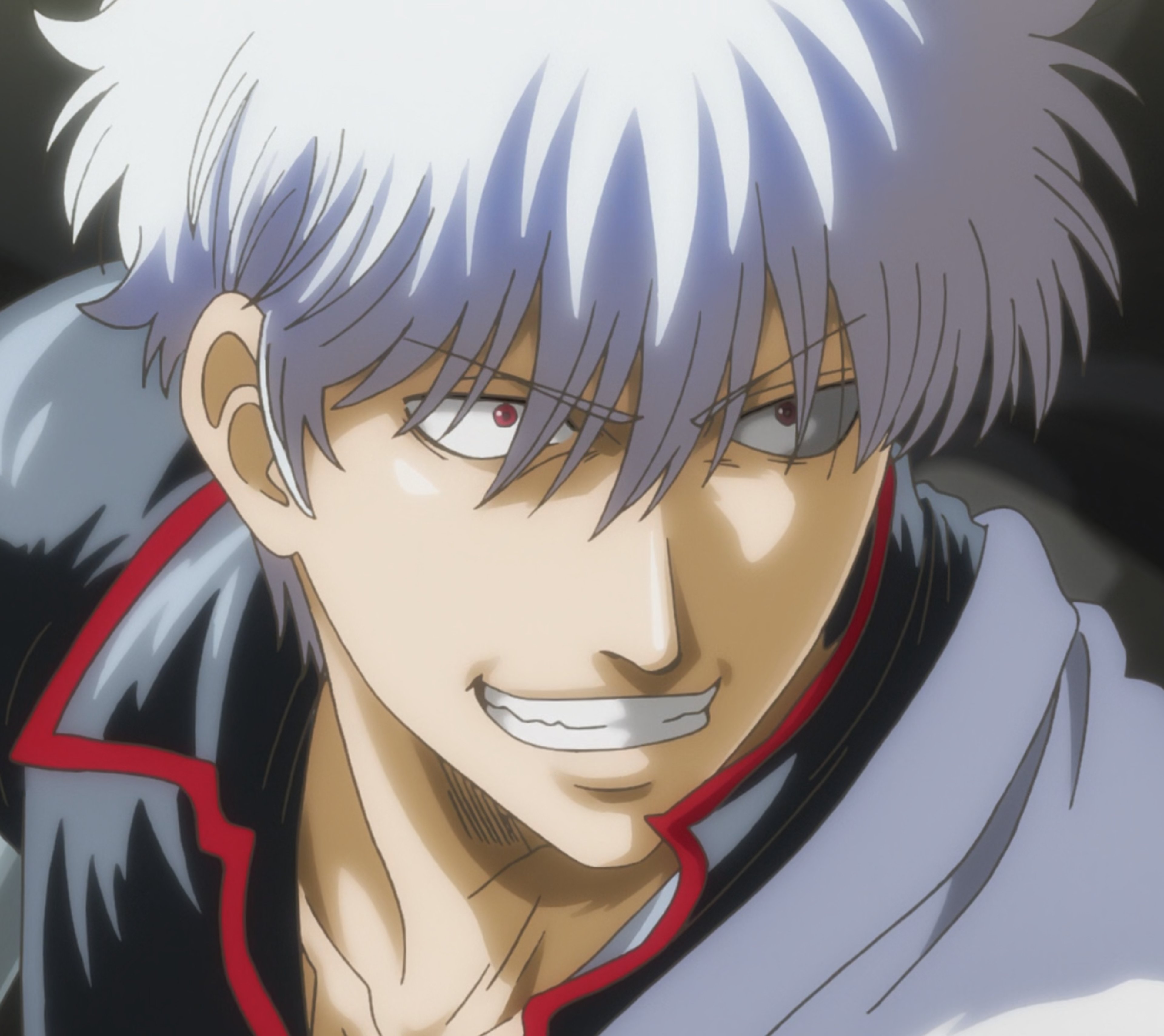 A man with silver hair and red eyes wearing a black and red outfit