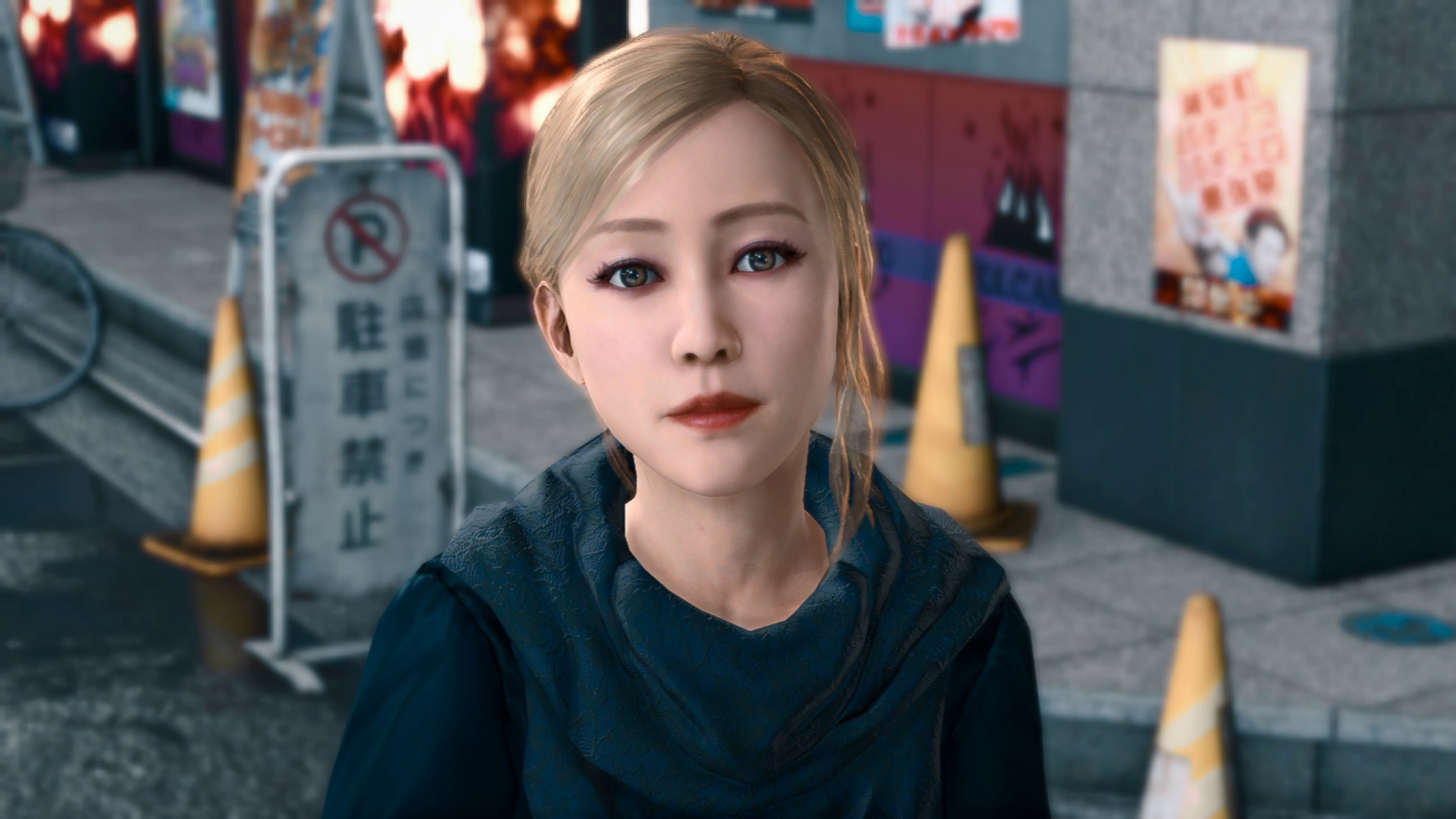 A young woman in a black robe standing in an urban setting