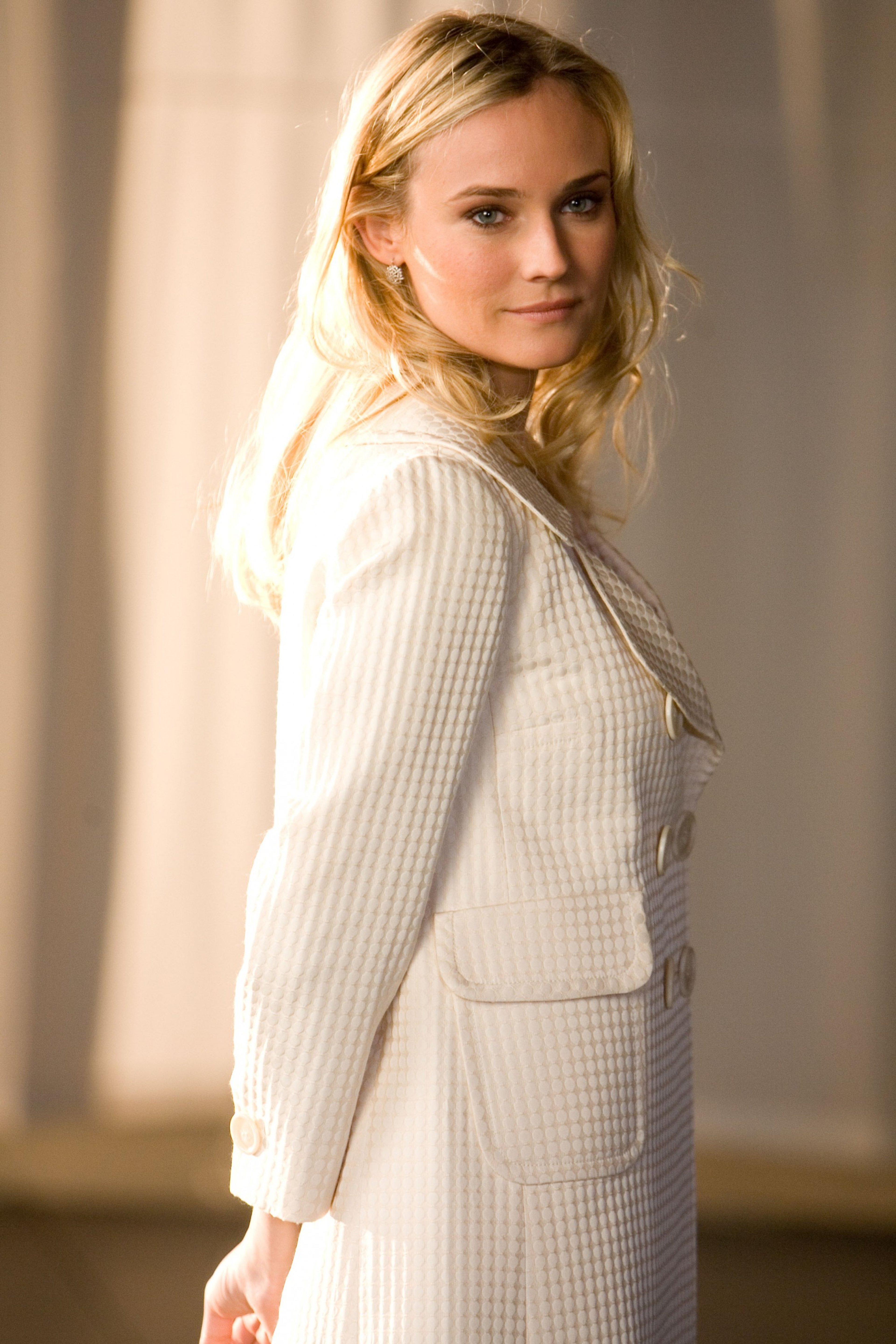 A woman with blonde hair wearing a white sweater