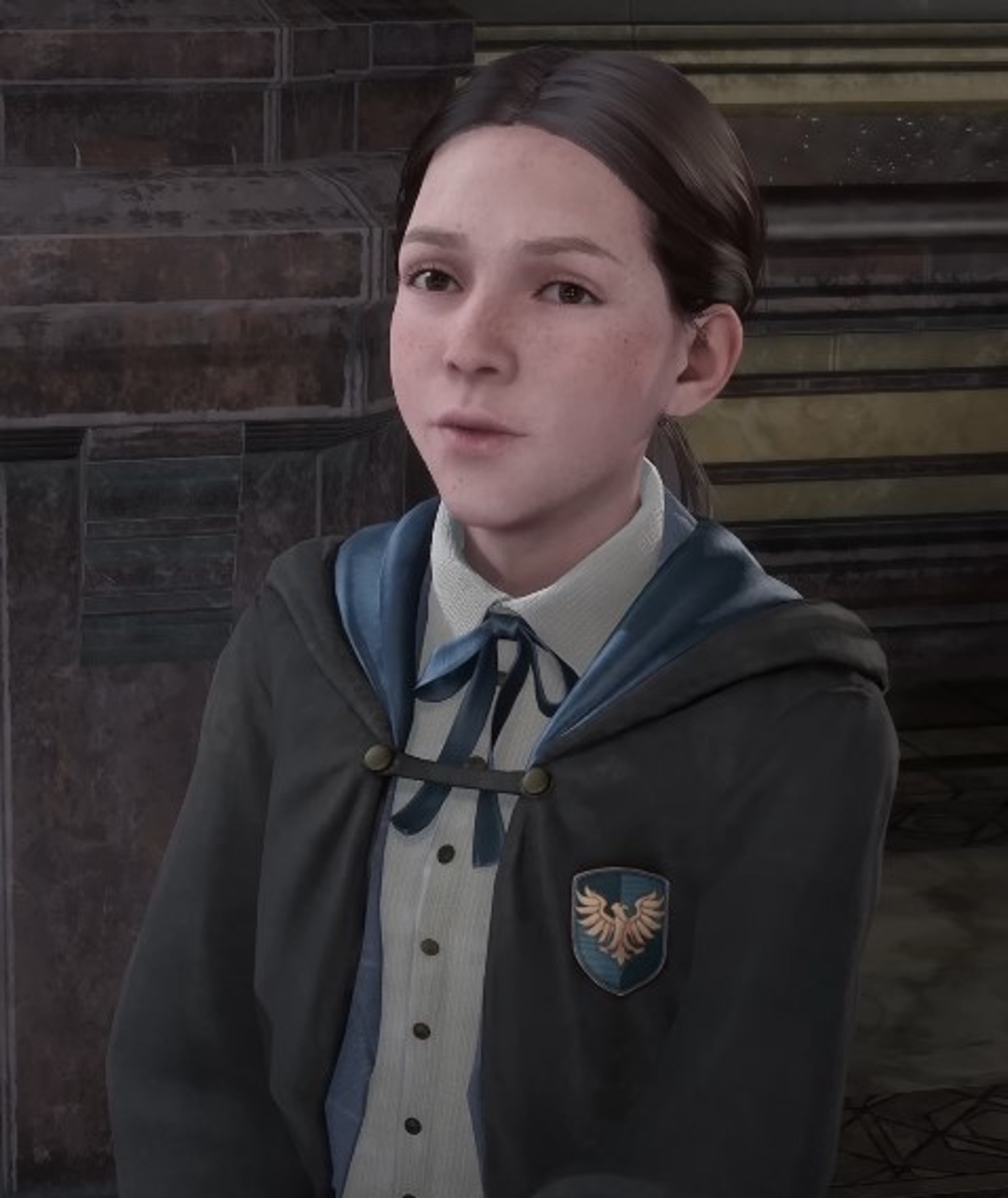 A young woman in a Hogwarts school uniform standing in front of a brick wall