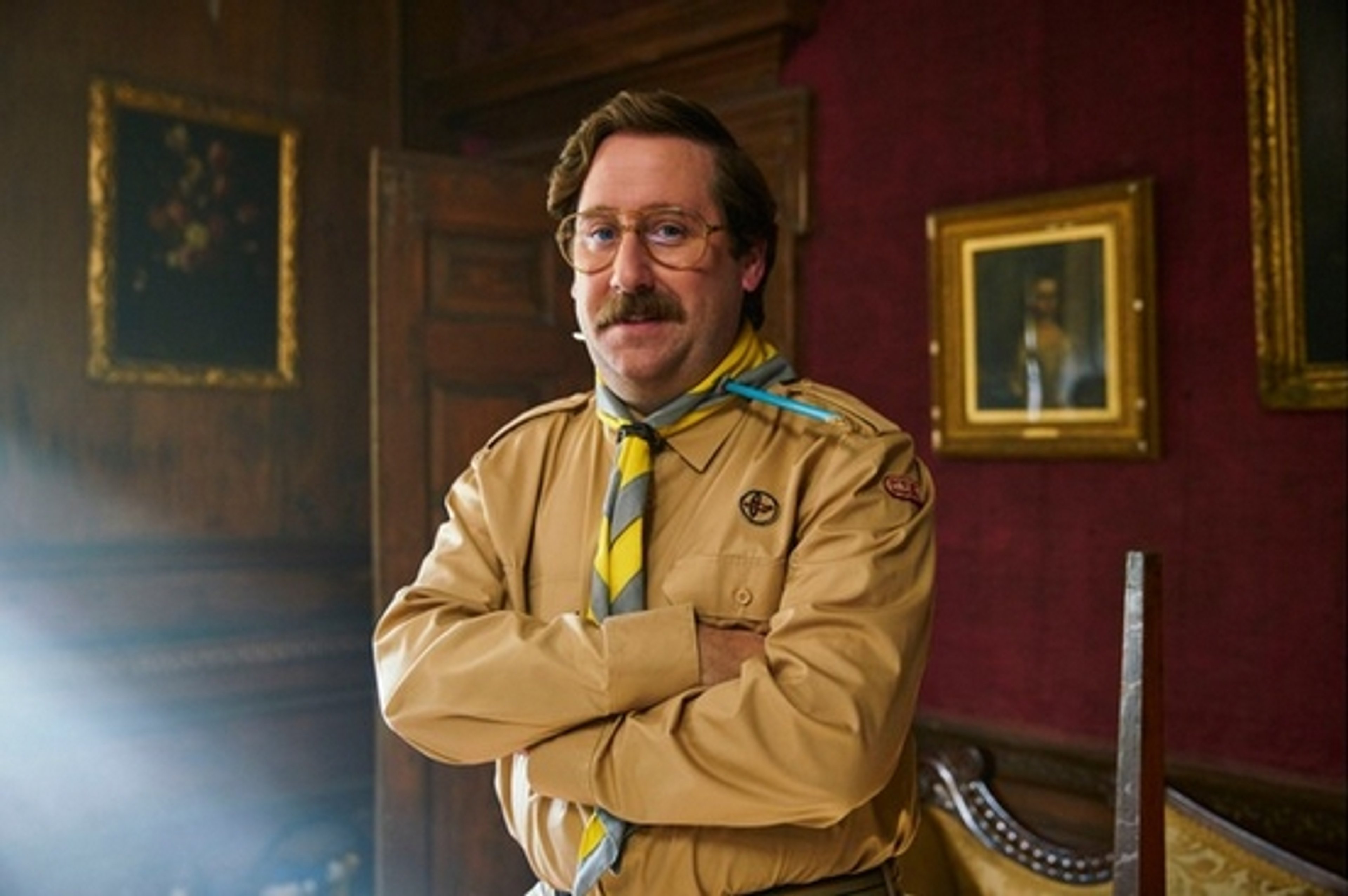 An older man in a scout uniform with a friendly expression