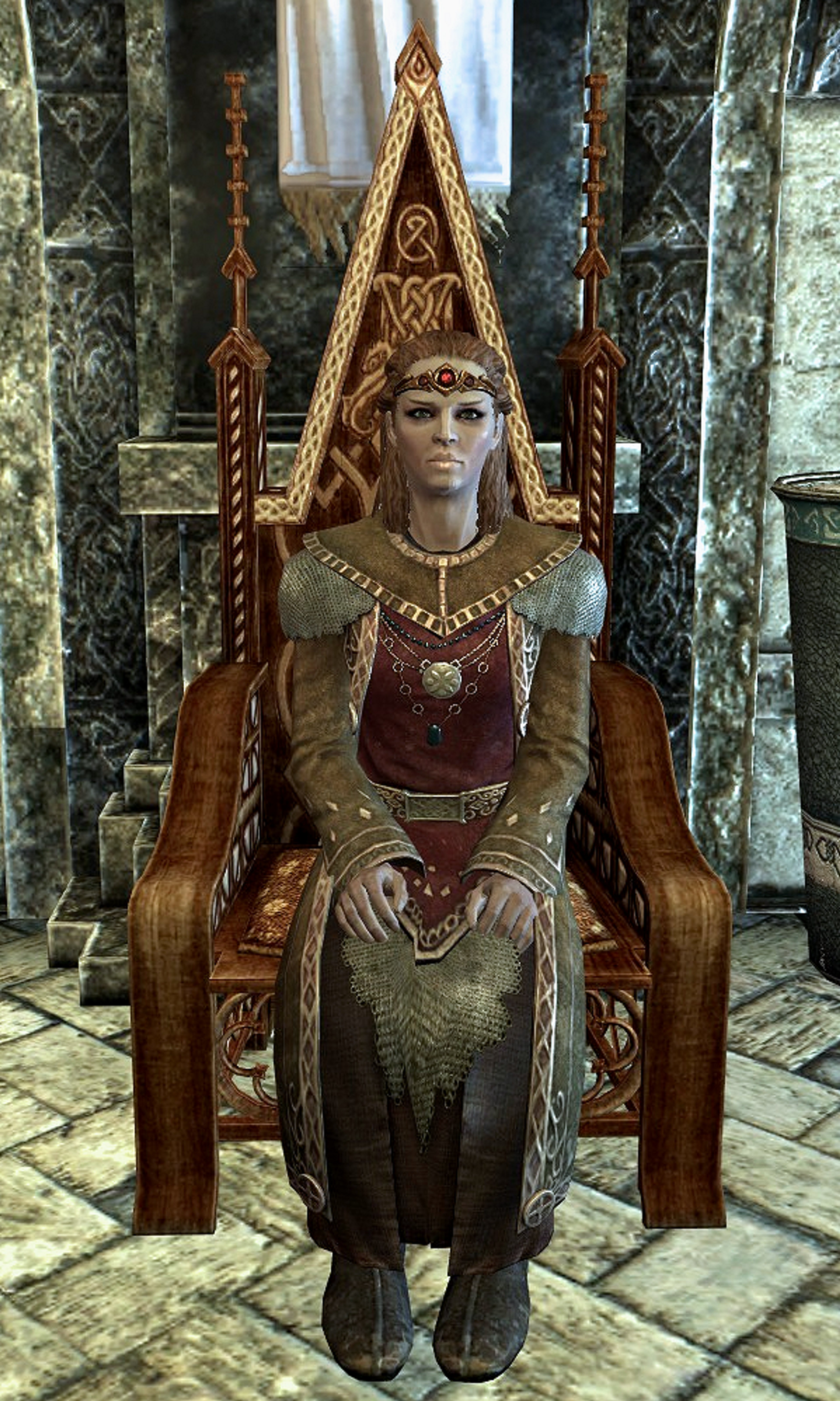 A woman in an ornate, fantasy-inspired outfit sitting on a throne-like chair in a grand, castle-like interior.