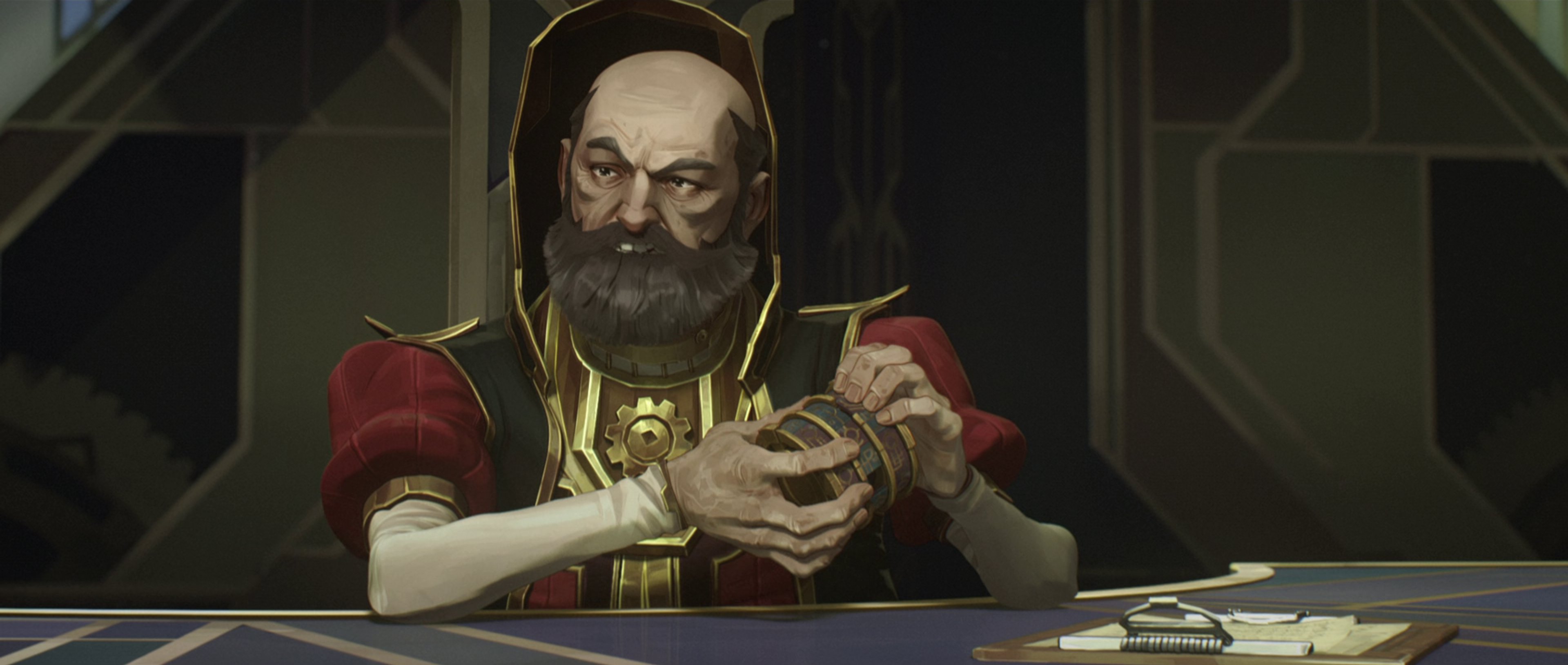An older man with a beard wearing a red robe, sitting at a desk