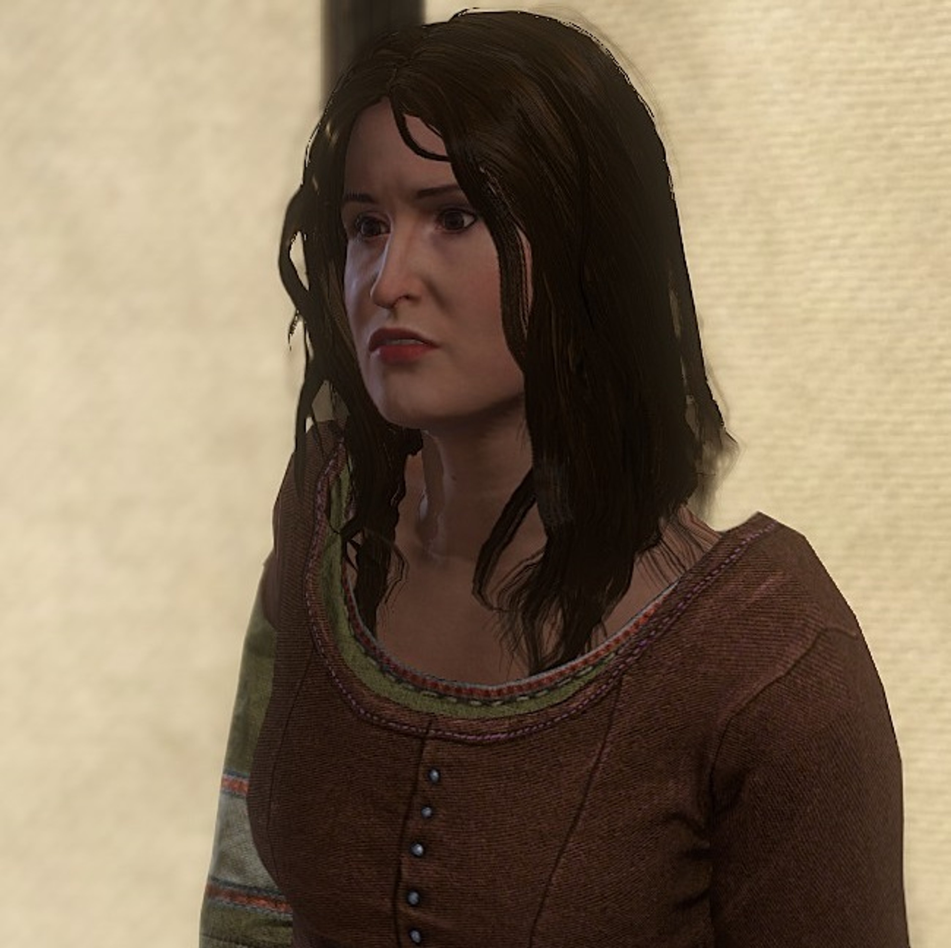 A young woman with long dark hair wearing a brown dress