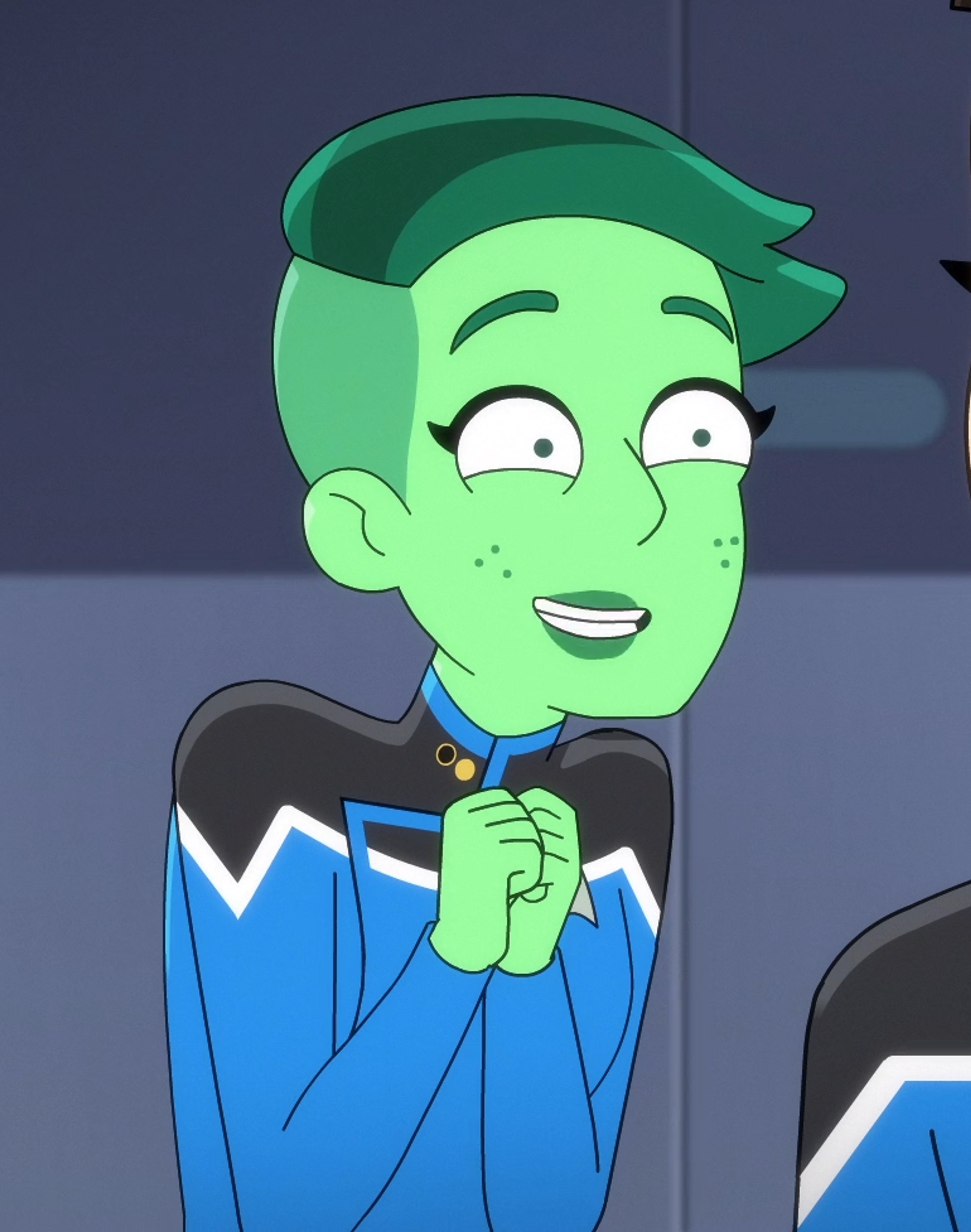 An animated green-skinned Orion Starfleet officer named Tendi, with a wide smile and blue uniform.