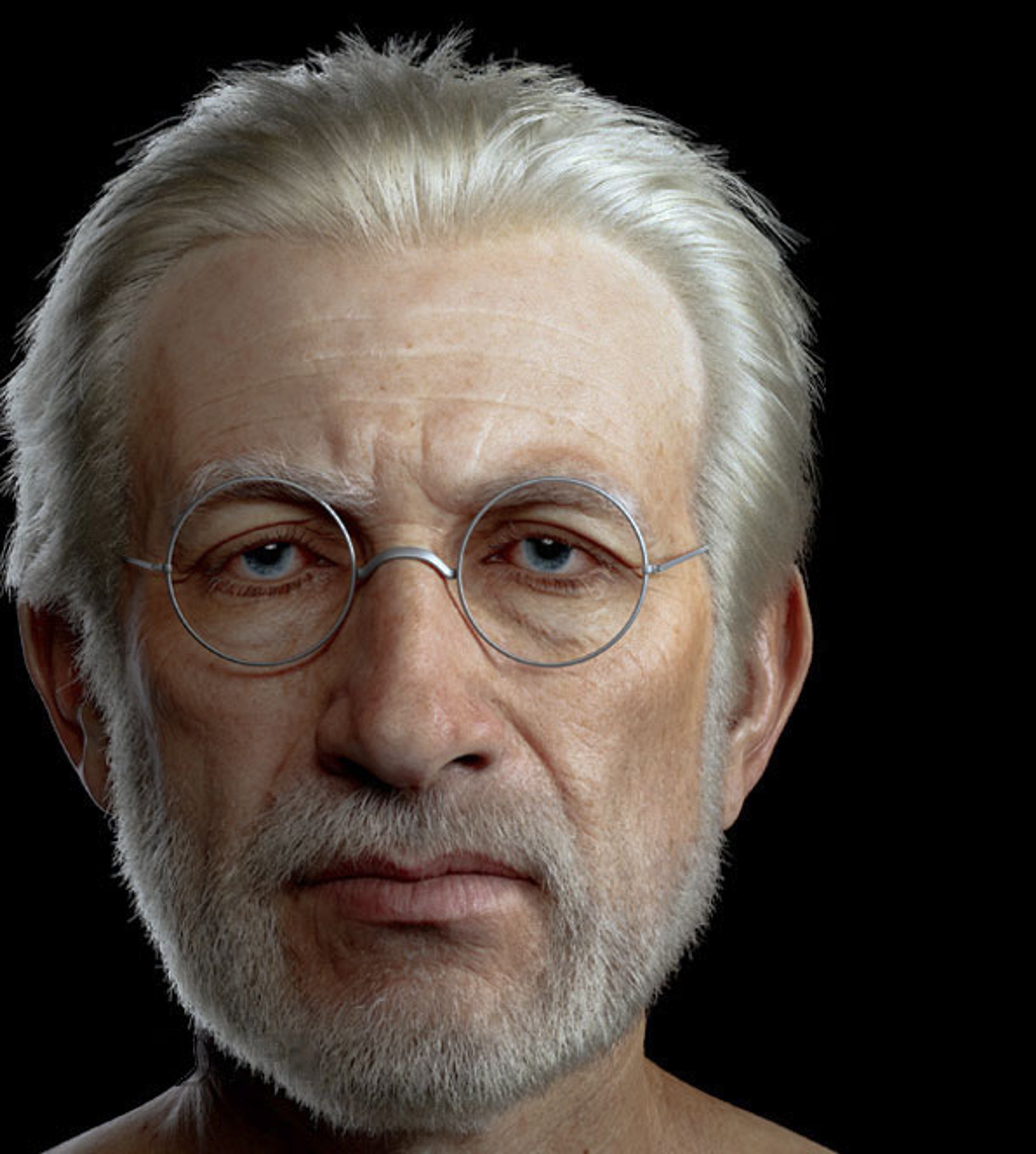 An elderly man with white hair and a beard, wearing glasses and a serious expression