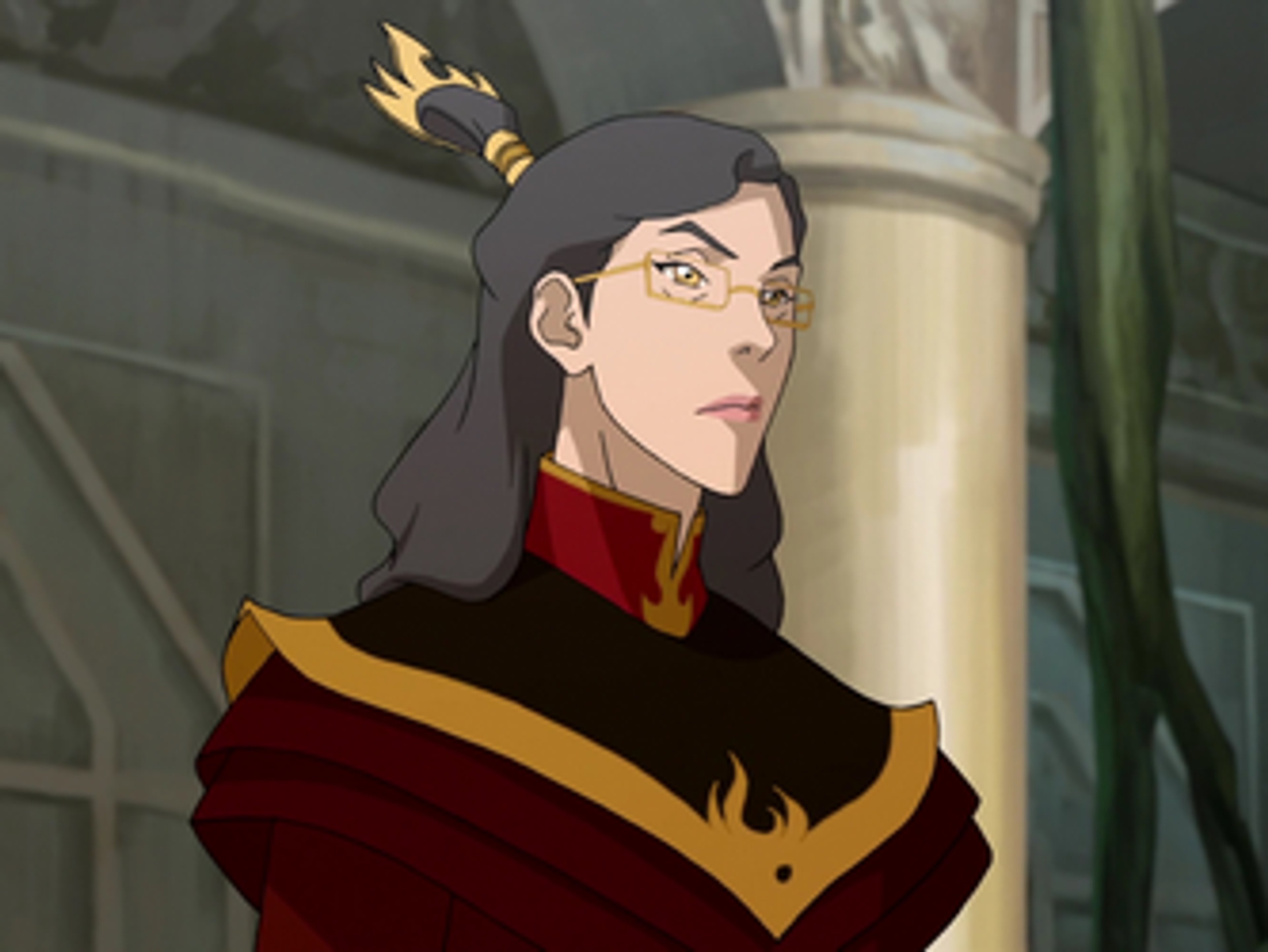 A woman with long dark hair wearing a red and gold outfit, with a determined expression on her face.