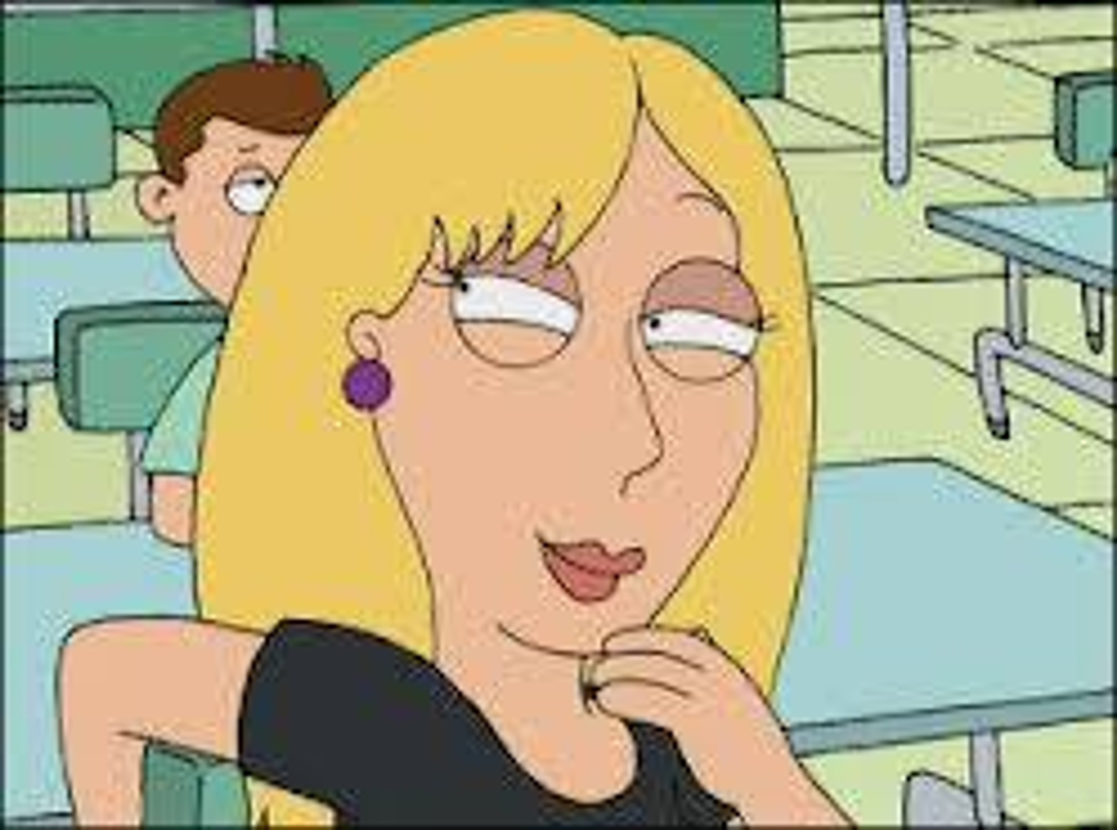 A blonde, attractive young woman with an hourglass figure and a confident, slightly mocking expression on her face.