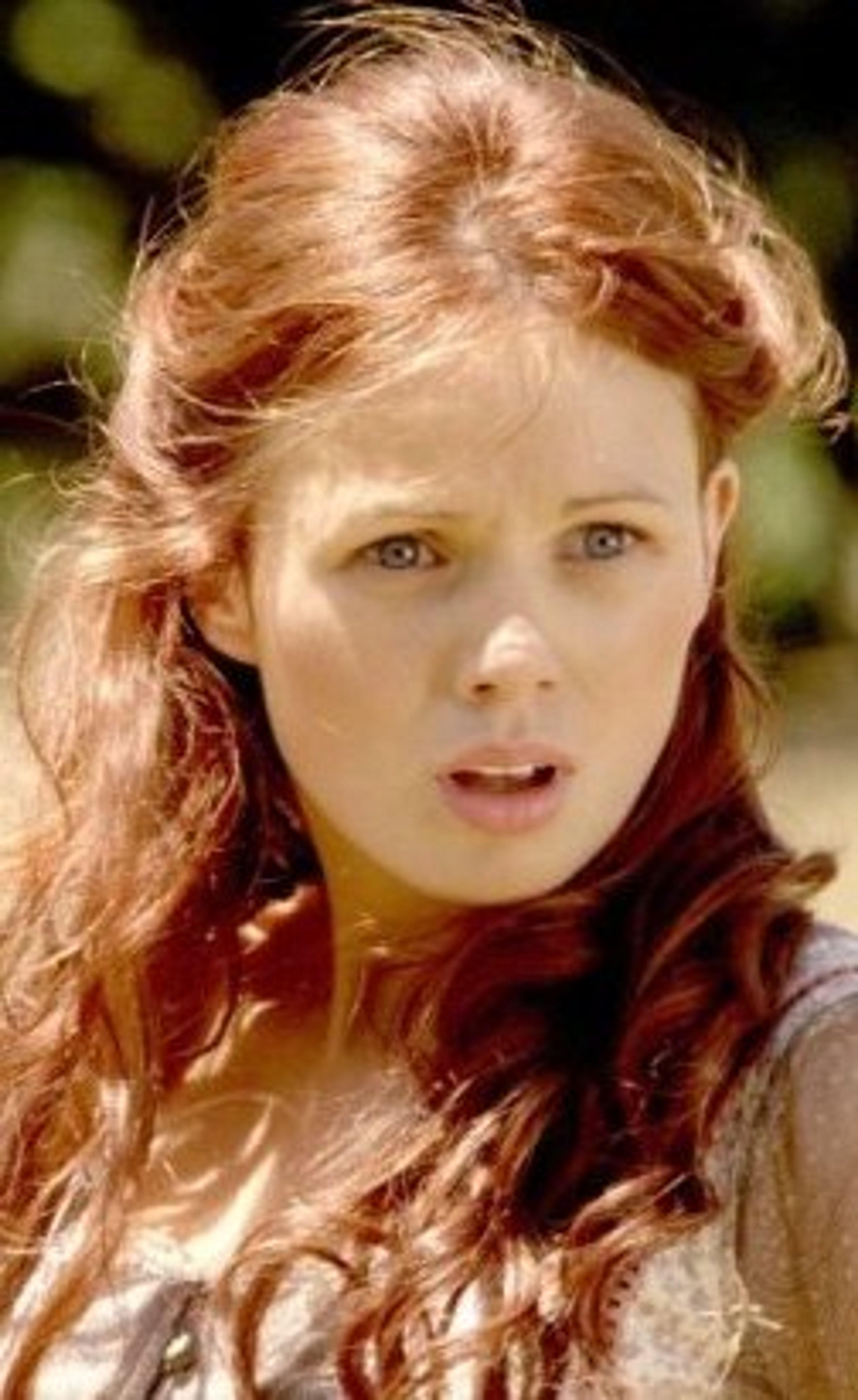 A young woman with red hair and blue eyes