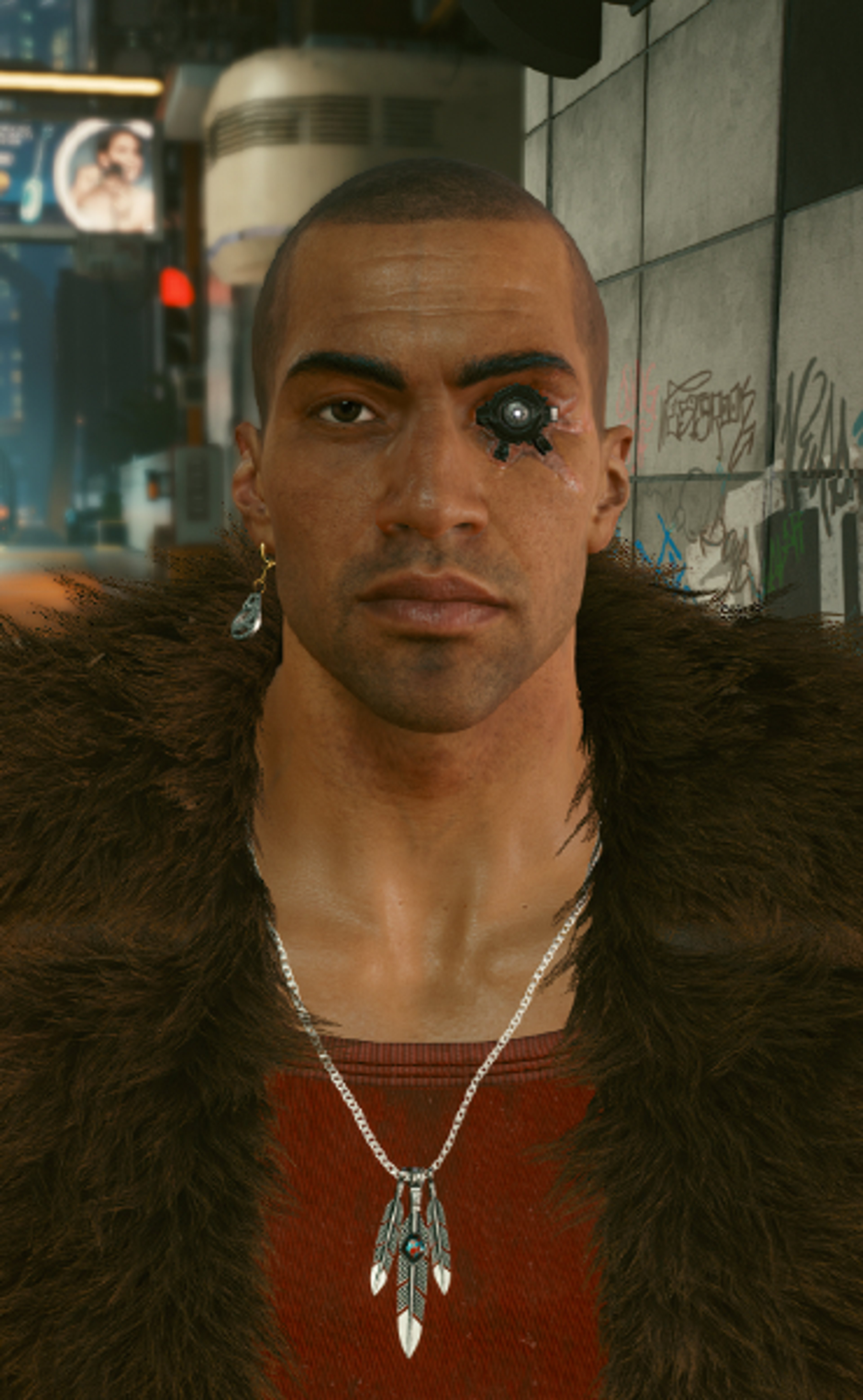 A man with a muscular build, shaved head, and facial piercings wearing a red shirt and fur-lined jacket.