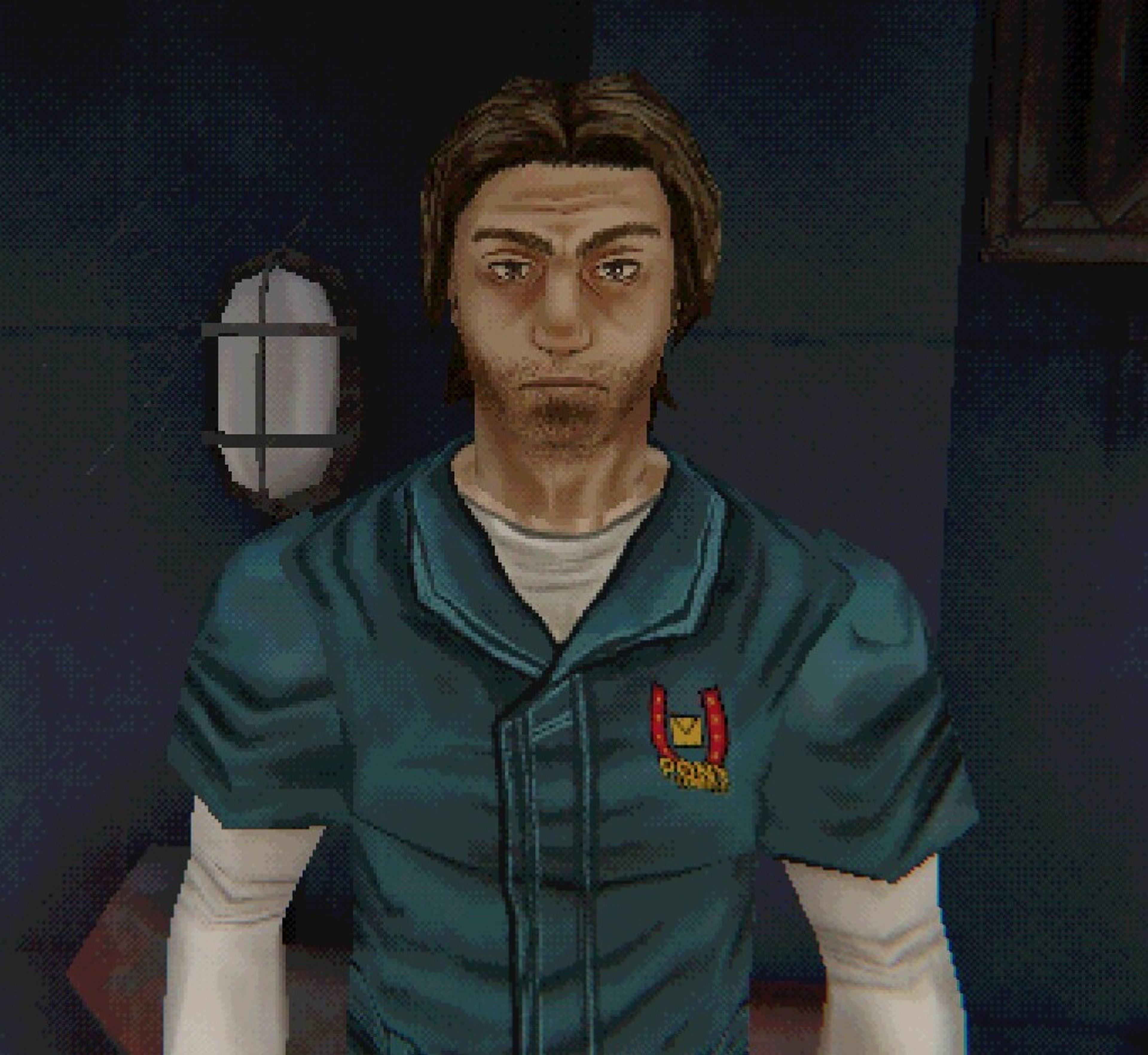 A man with long brown hair and a beard wearing a green jacket with a patch