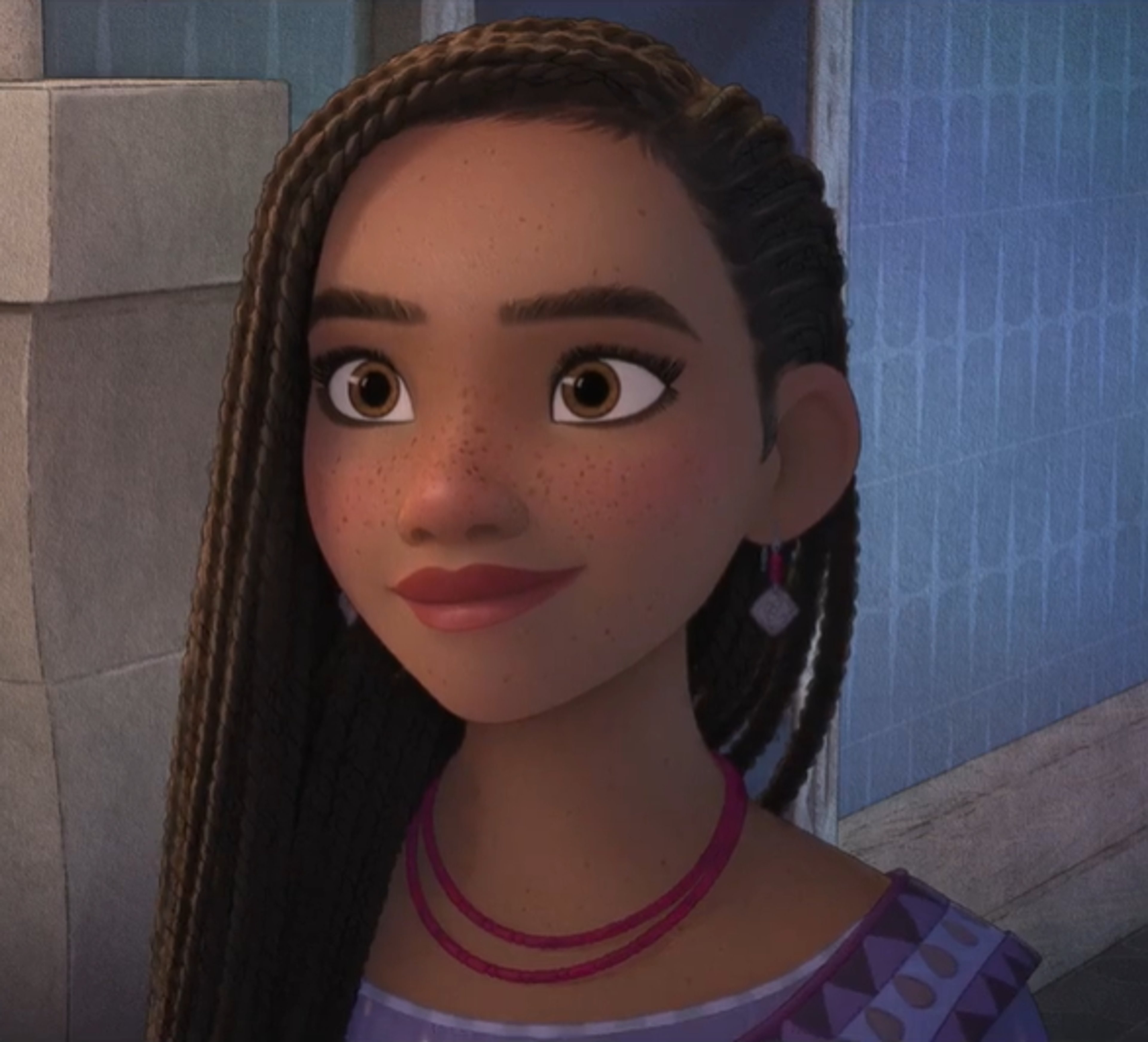 A young woman with braided hair wearing a purple top