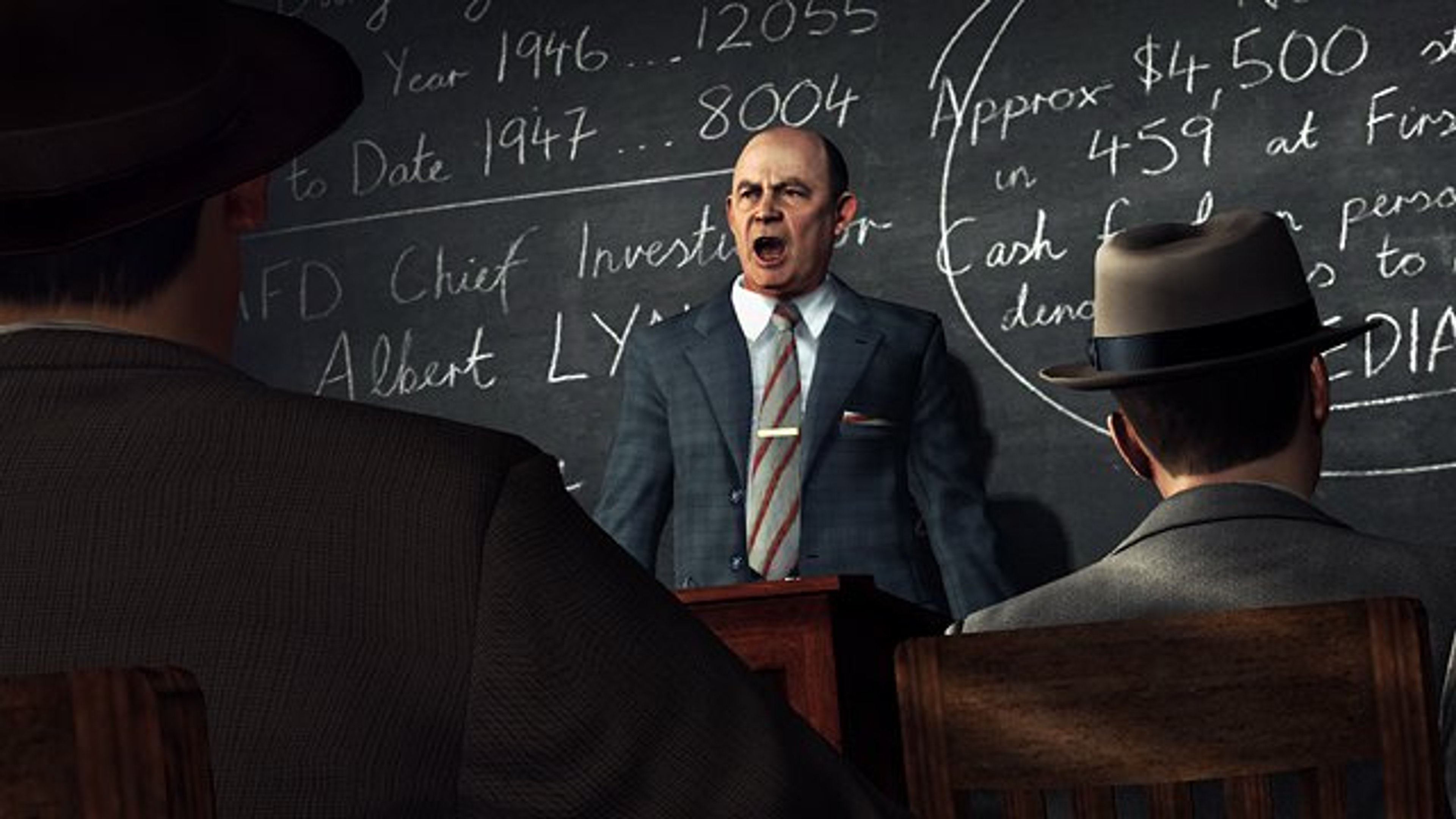 A middle-aged man in a suit and tie, likely a police officer, standing in front of a chalkboard