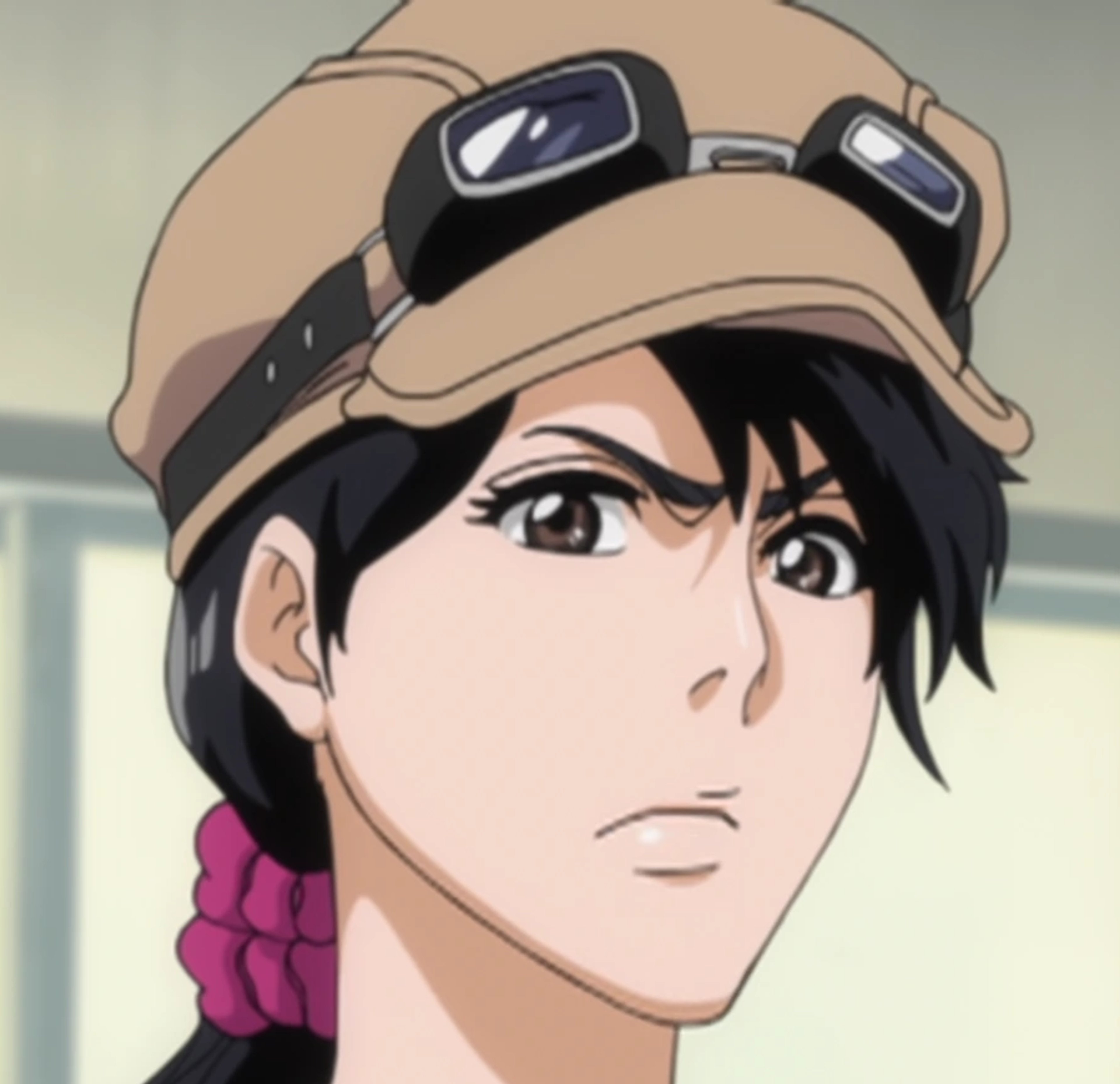 An anime-style character with dark hair, a tan hat, and a serious expression