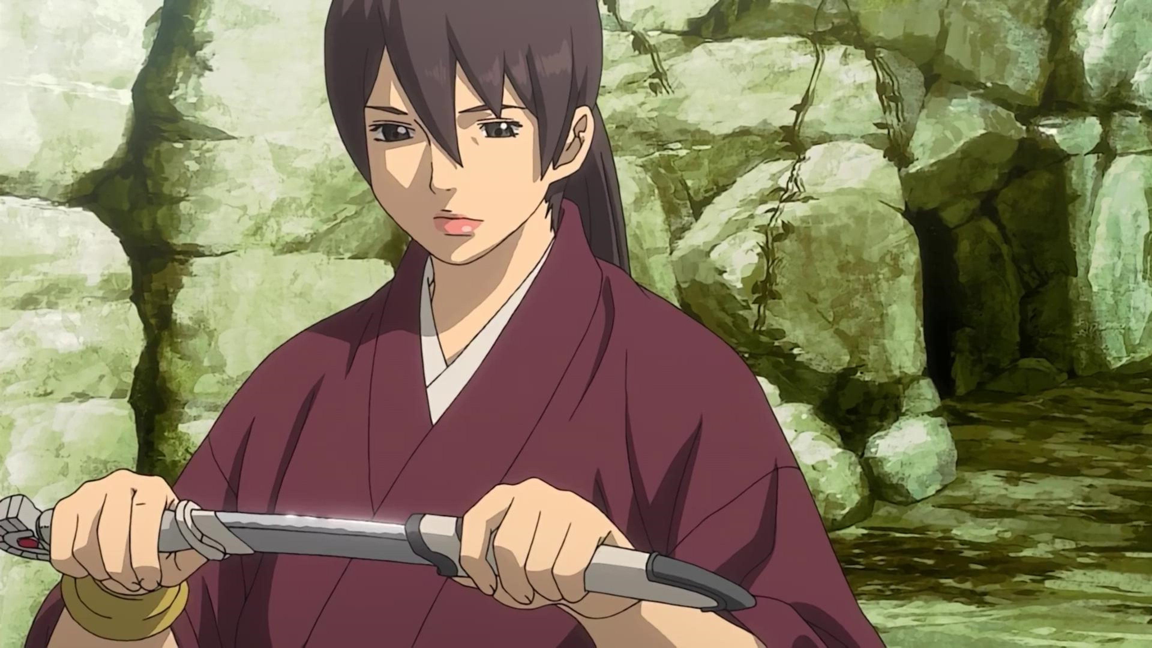 A young woman in a red robe holding a spear in a defensive stance.