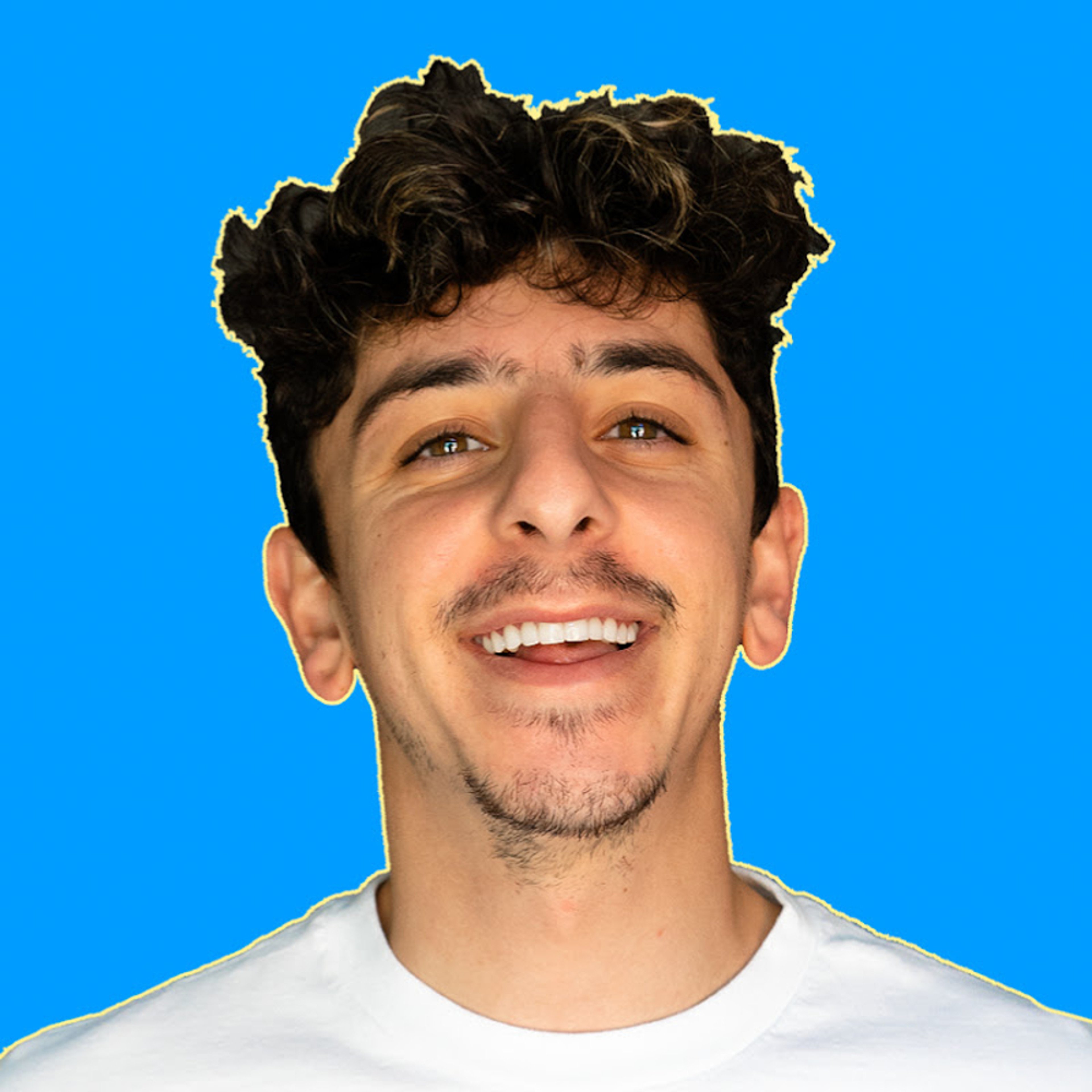 A young man with curly dark hair smiling at the camera