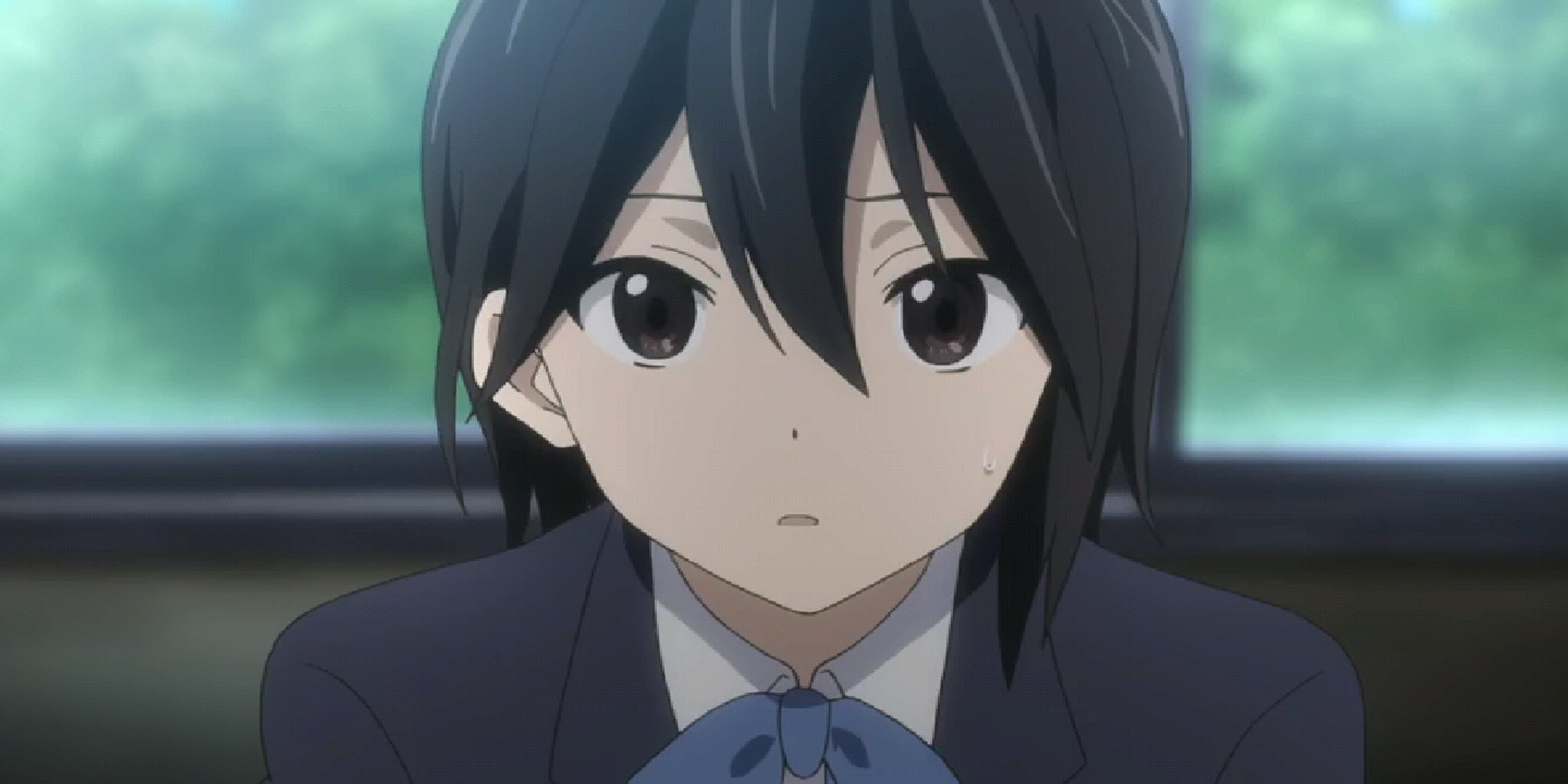 A young woman with black hair and brown eyes wearing a school uniform