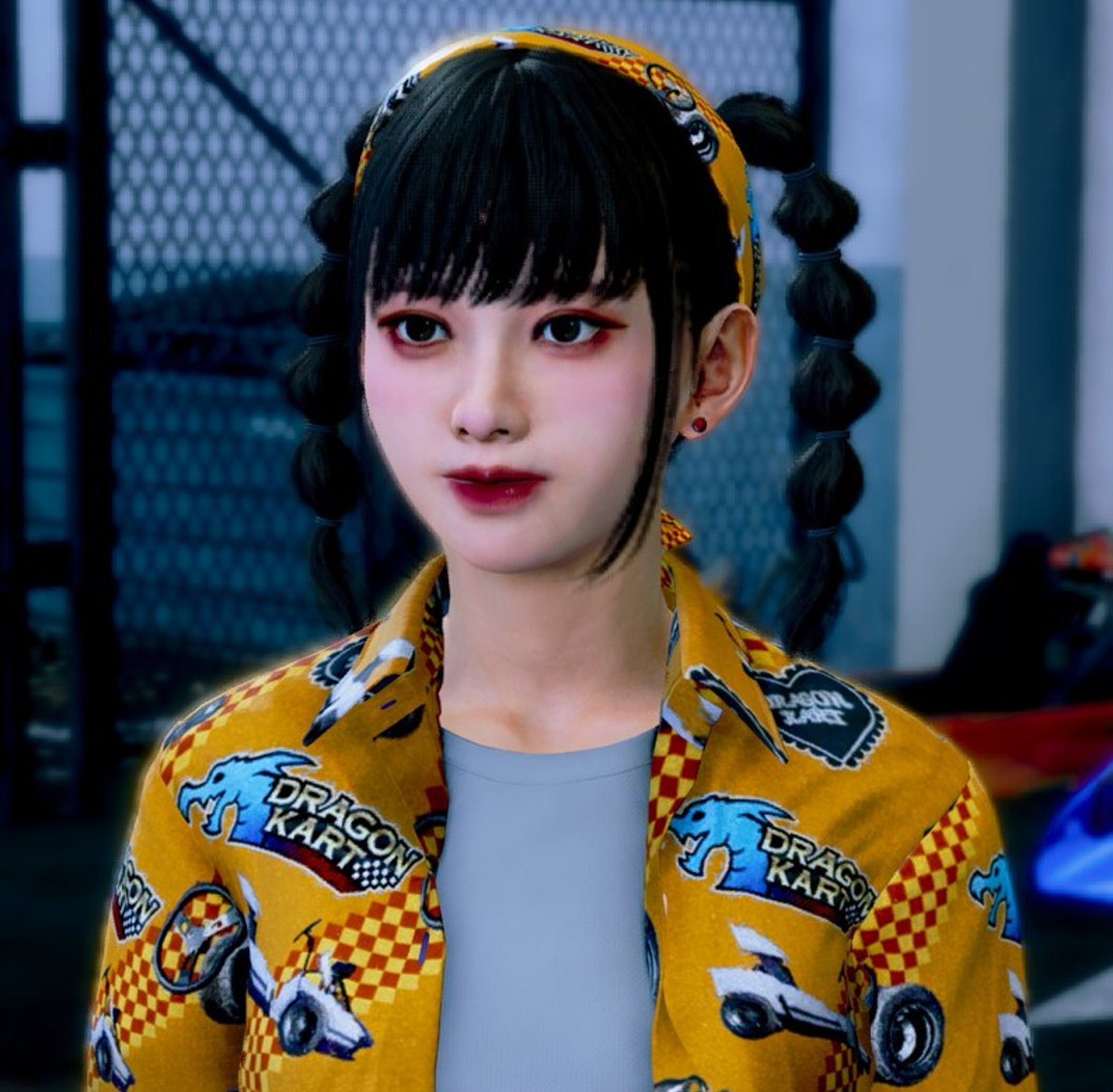 A young woman with short black hair wearing a yellow checkered jacket, smiling and looking directly at the camera.