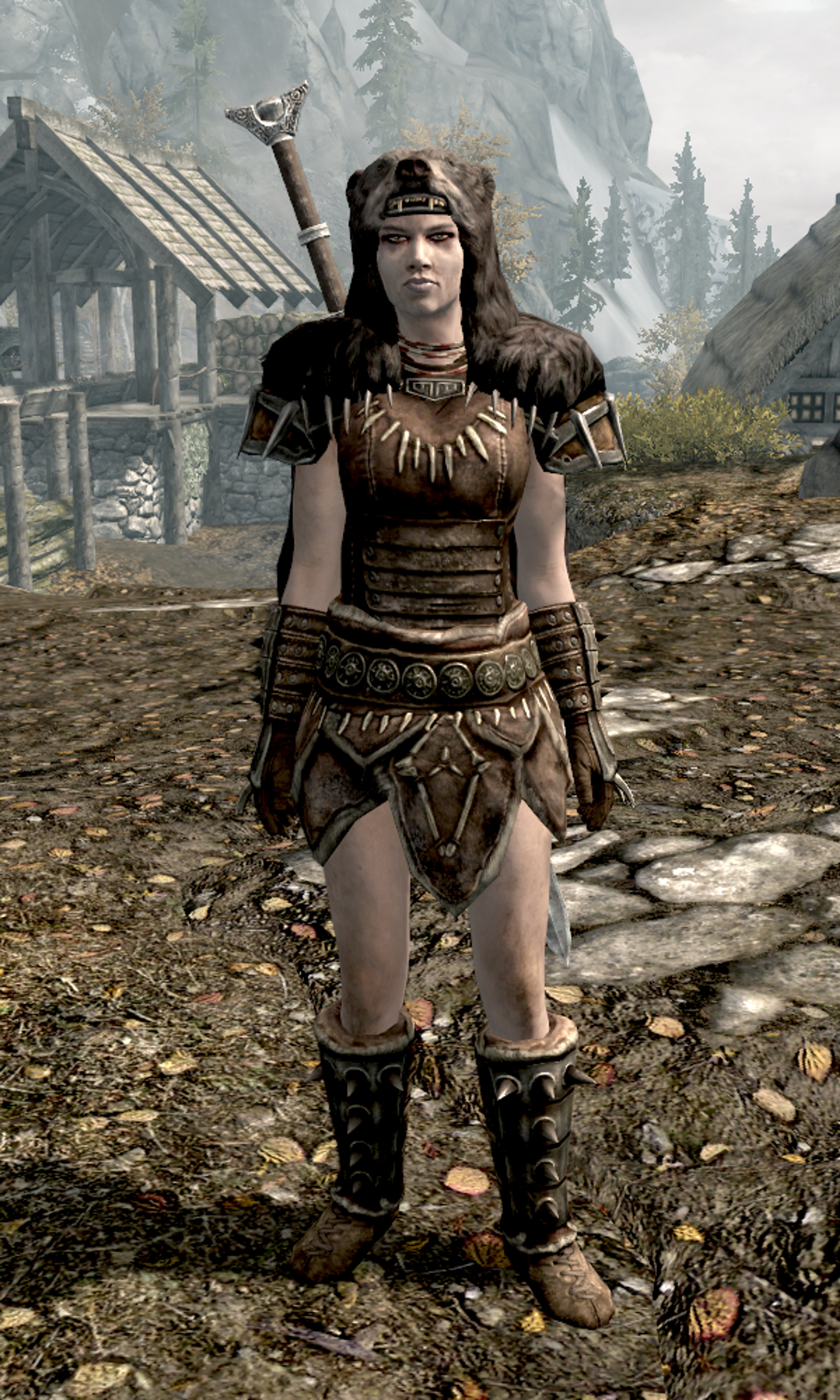 A Nord warrior woman in Stormcloak armor, holding a sword.