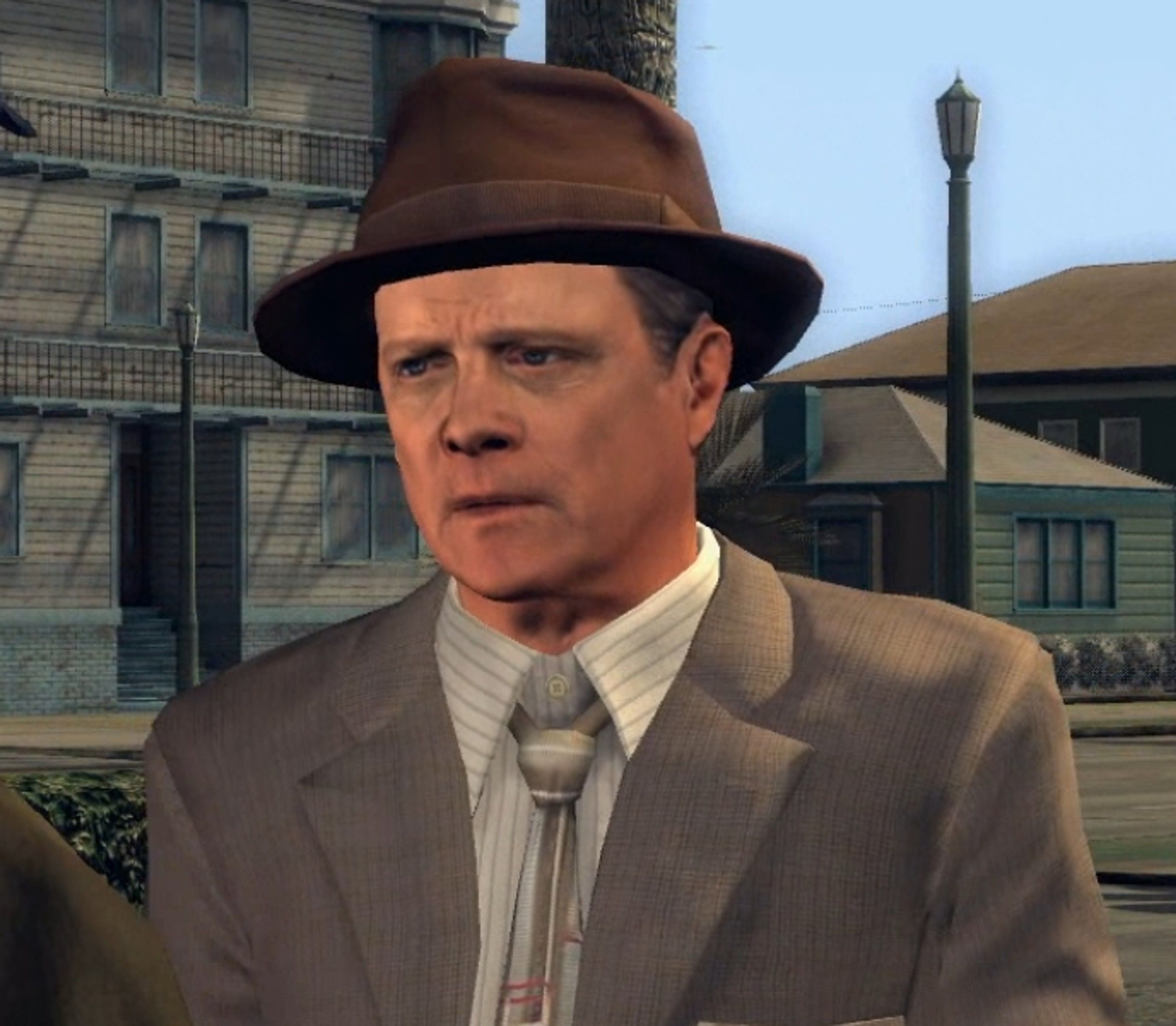 A middle-aged man with a grizzled appearance wearing a fedora hat and suit