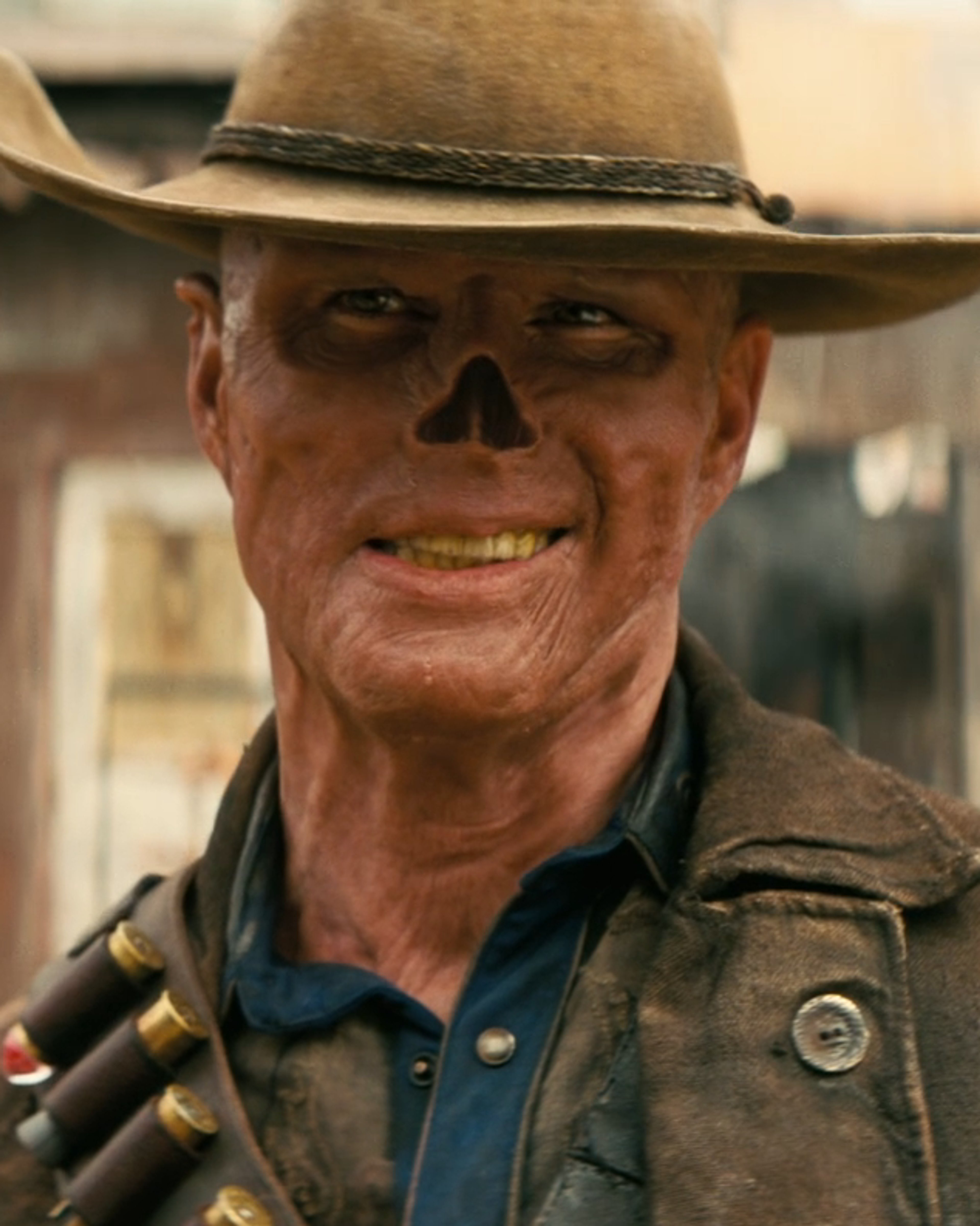 A rugged, weathered-looking man in a cowboy hat and military-style outfit