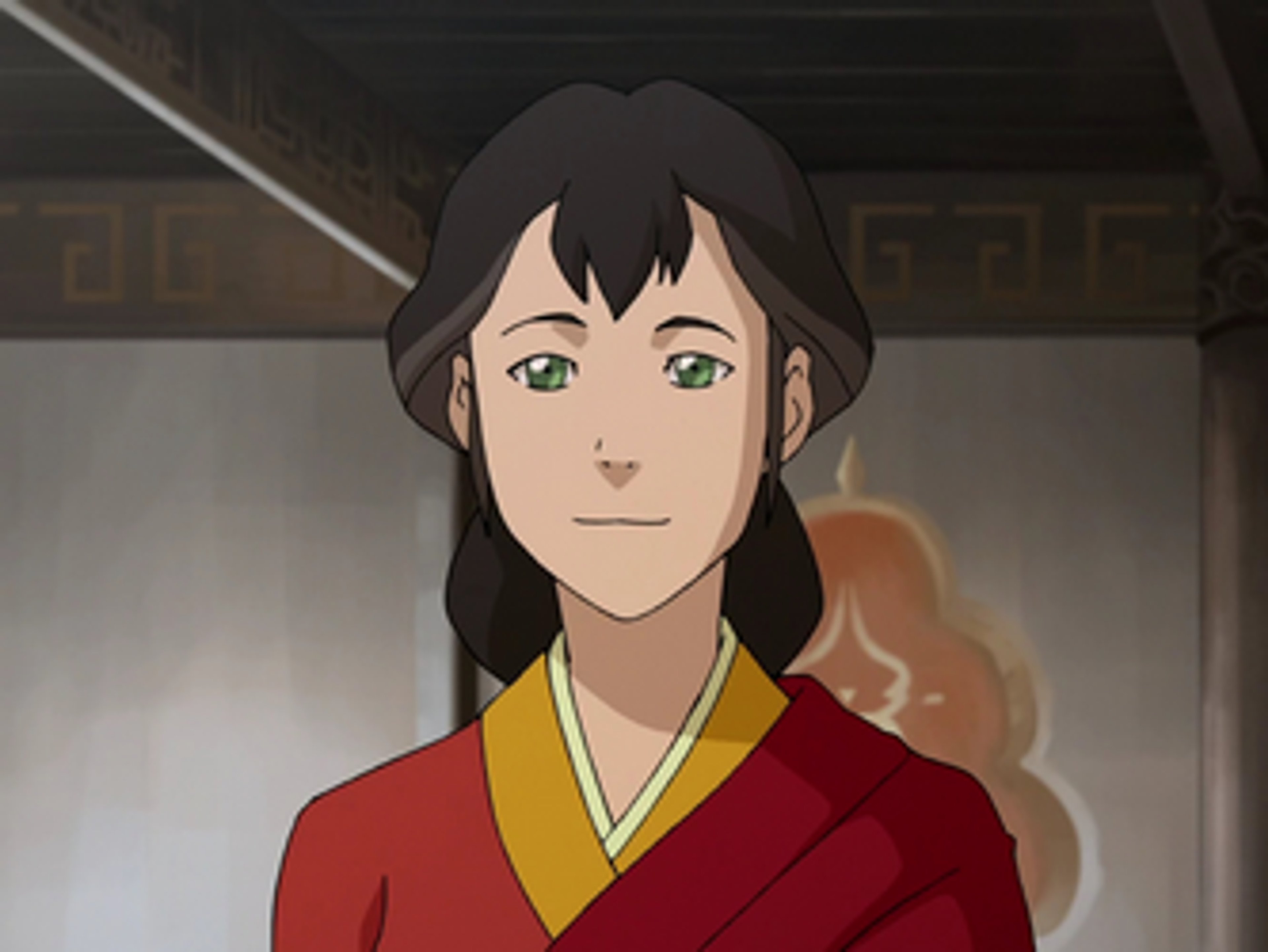 A woman with long dark hair wearing a red and yellow robe