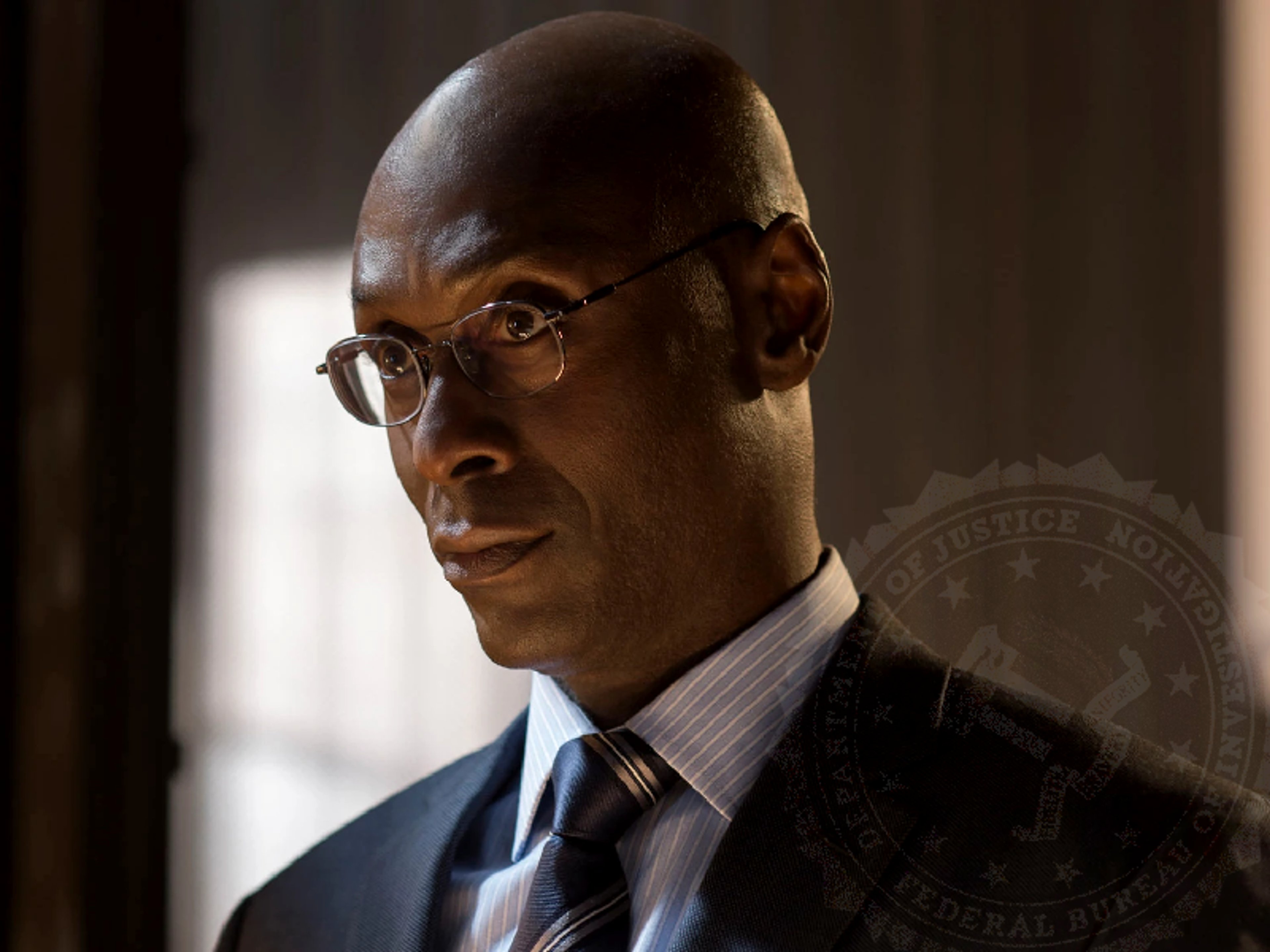 A serious-looking African American man in a suit