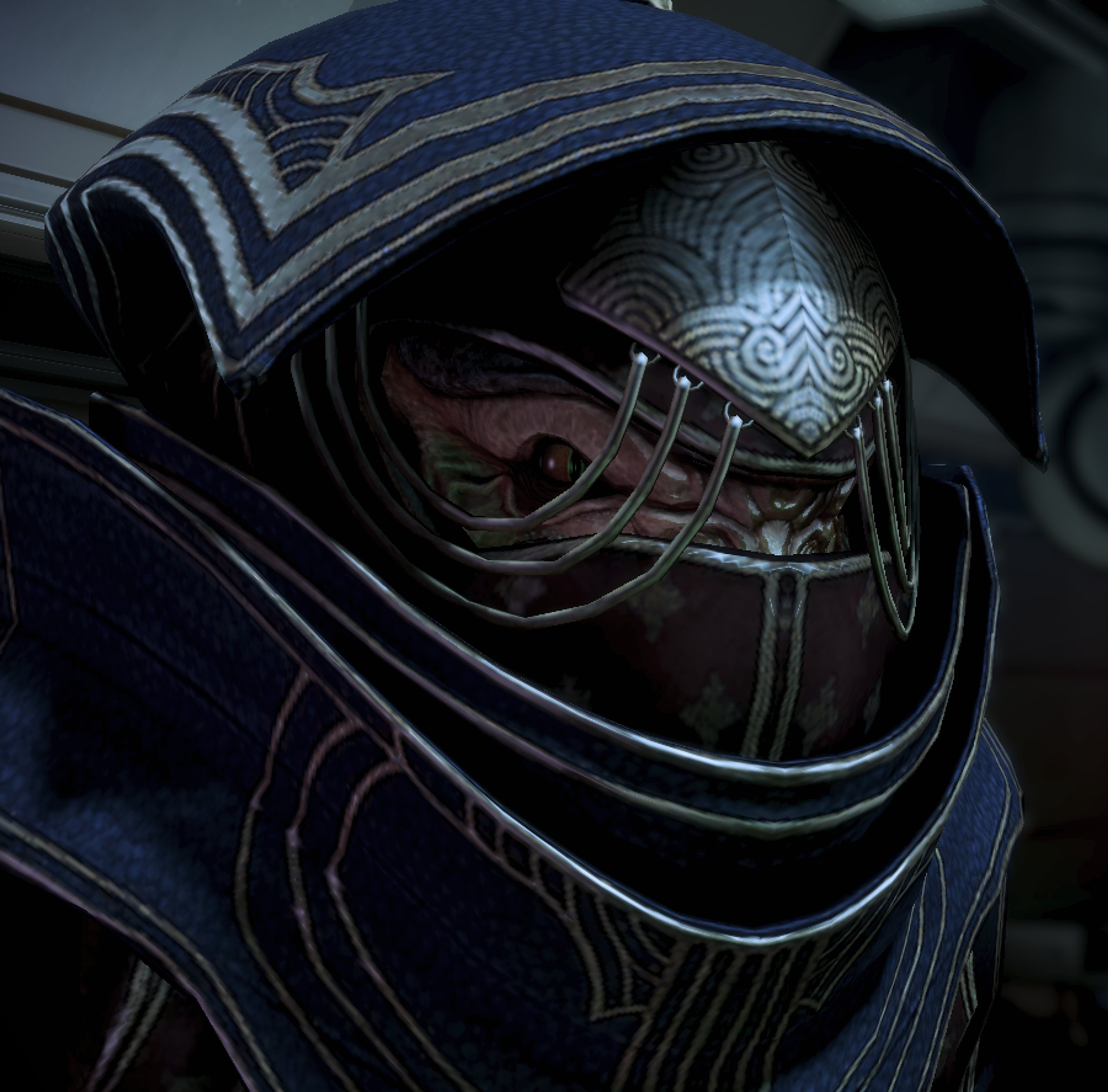 A close-up view of a female krogan character wearing a dark, ornate helmet or mask.
