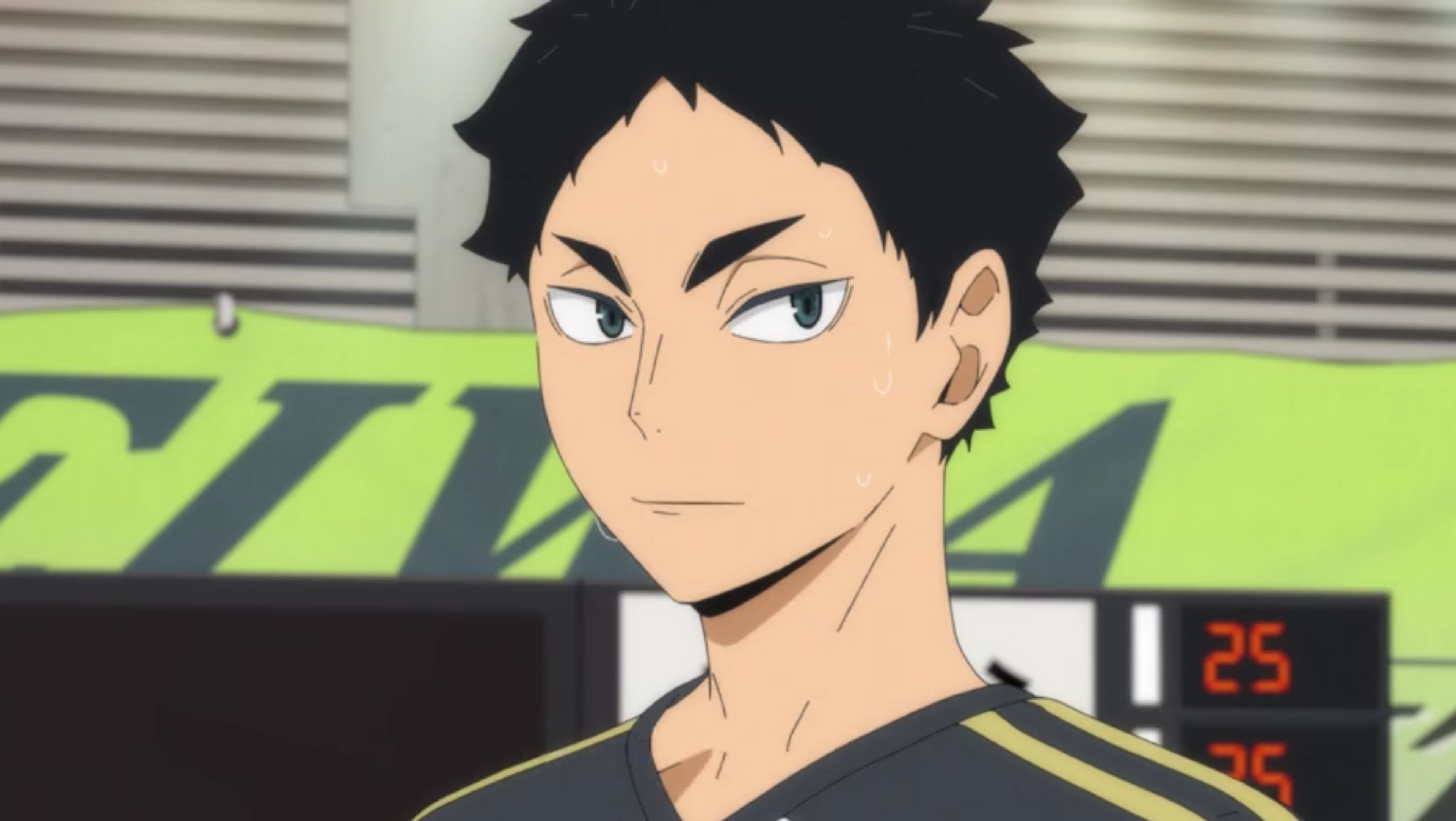 A young man in a volleyball uniform with a serious expression