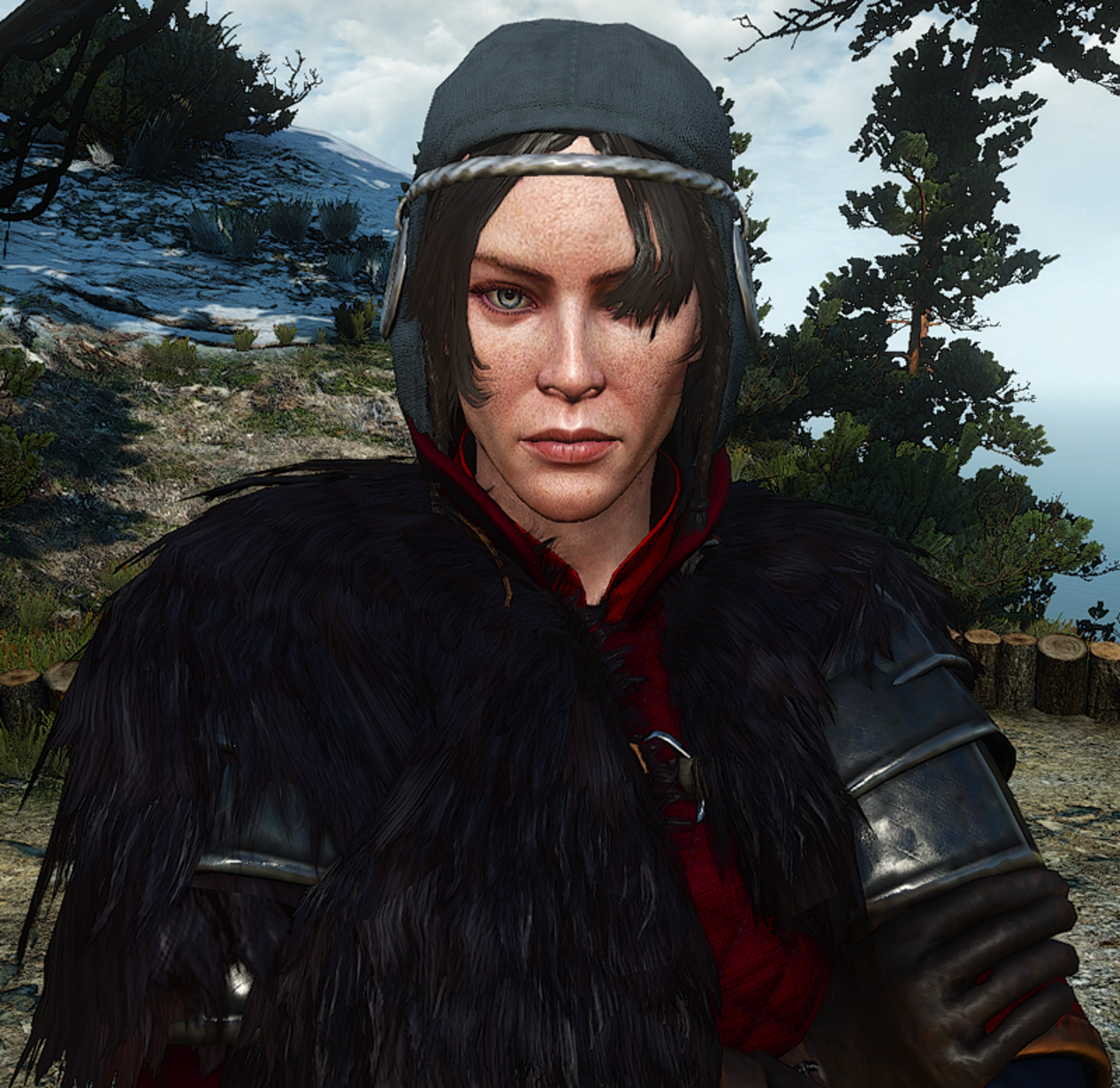 A fierce-looking warrior woman in a black fur-lined coat and cap, set against a mountainous landscape.