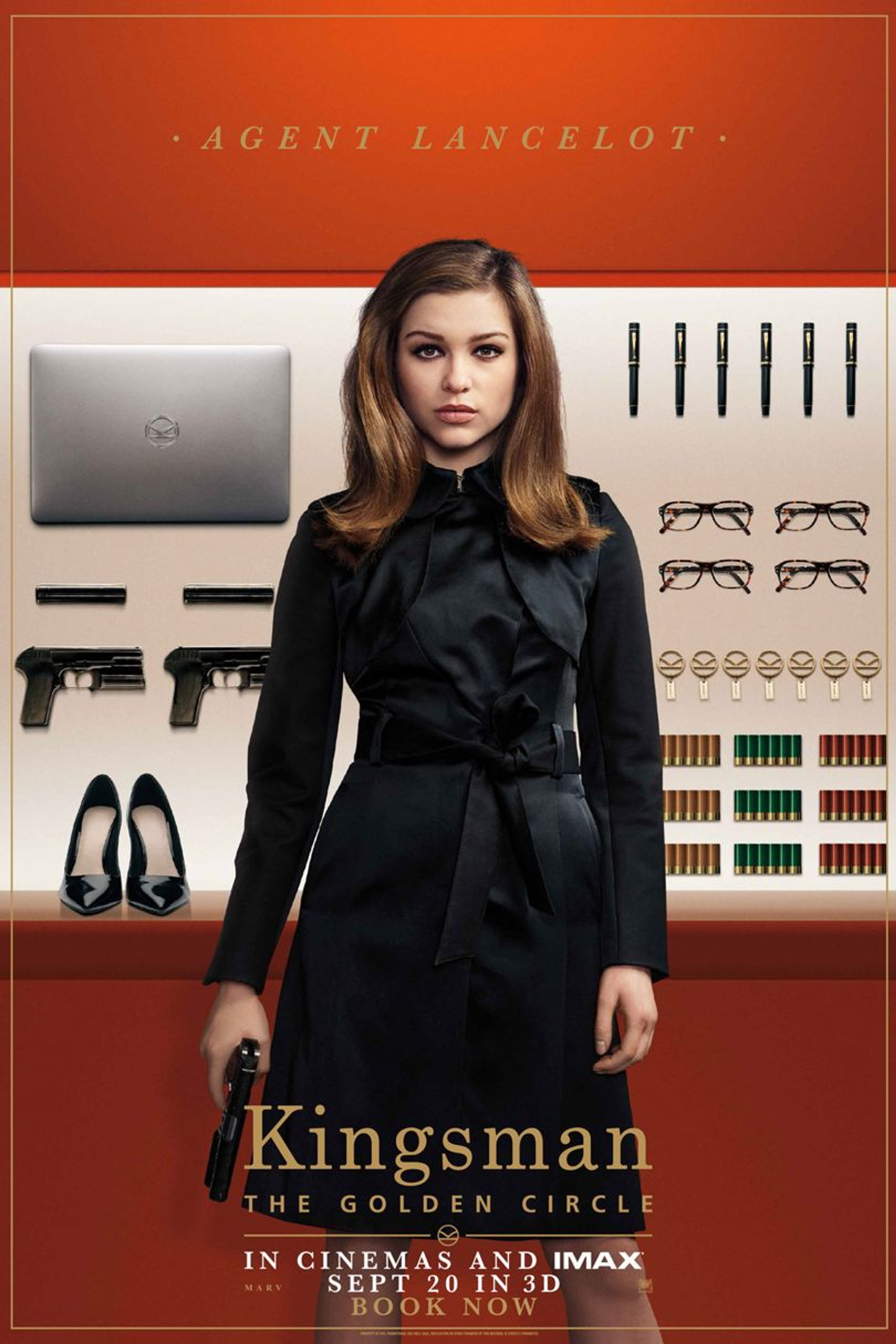 A woman in a black coat standing in front of a Kingsman logo backdrop
