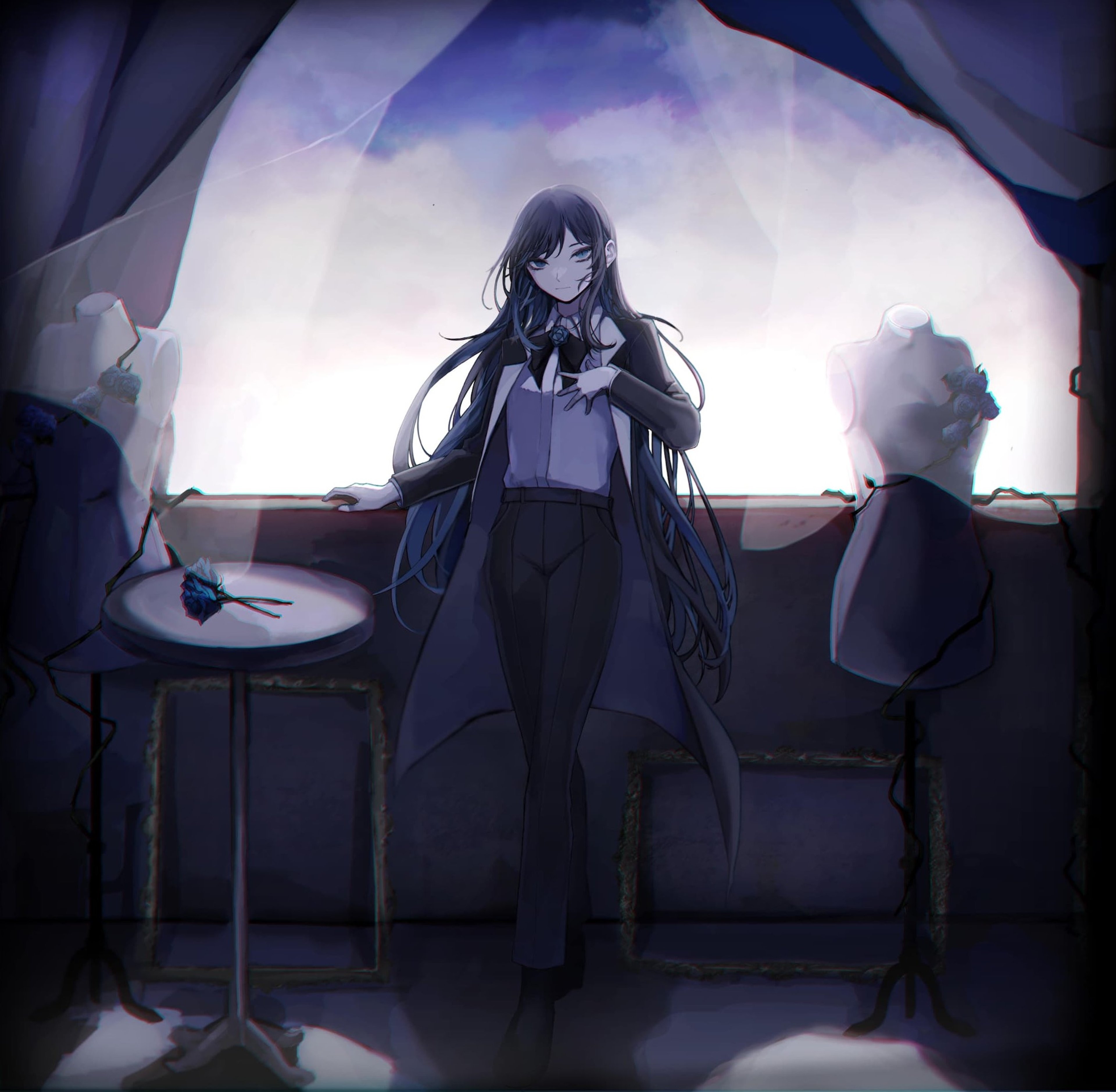 A young woman with dark hair wearing a black outfit in a dimly lit setting
