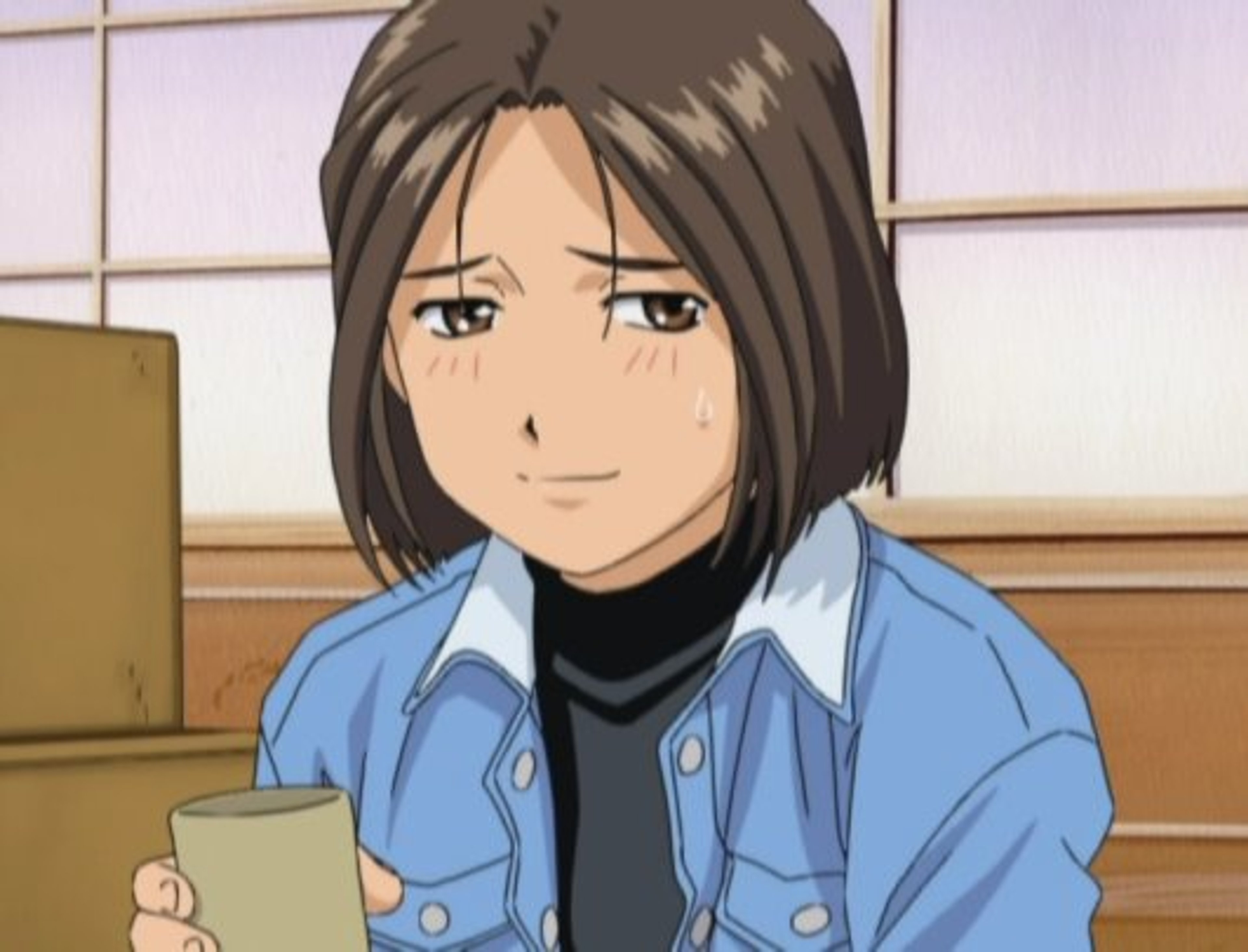 A young woman with short, dark hair wearing a blue denim jacket