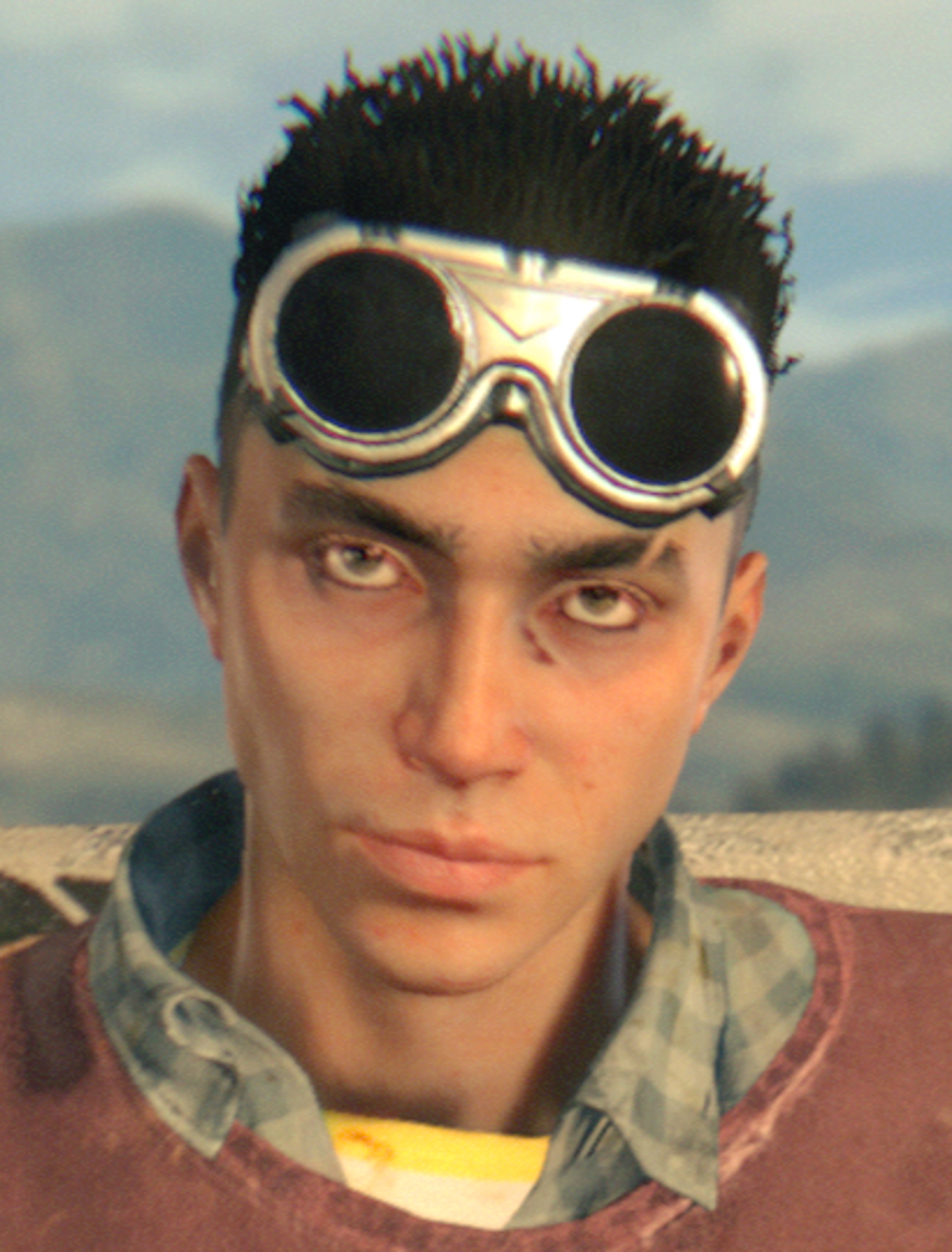 A young man with dark hair wearing large round goggles in a post-apocalyptic setting