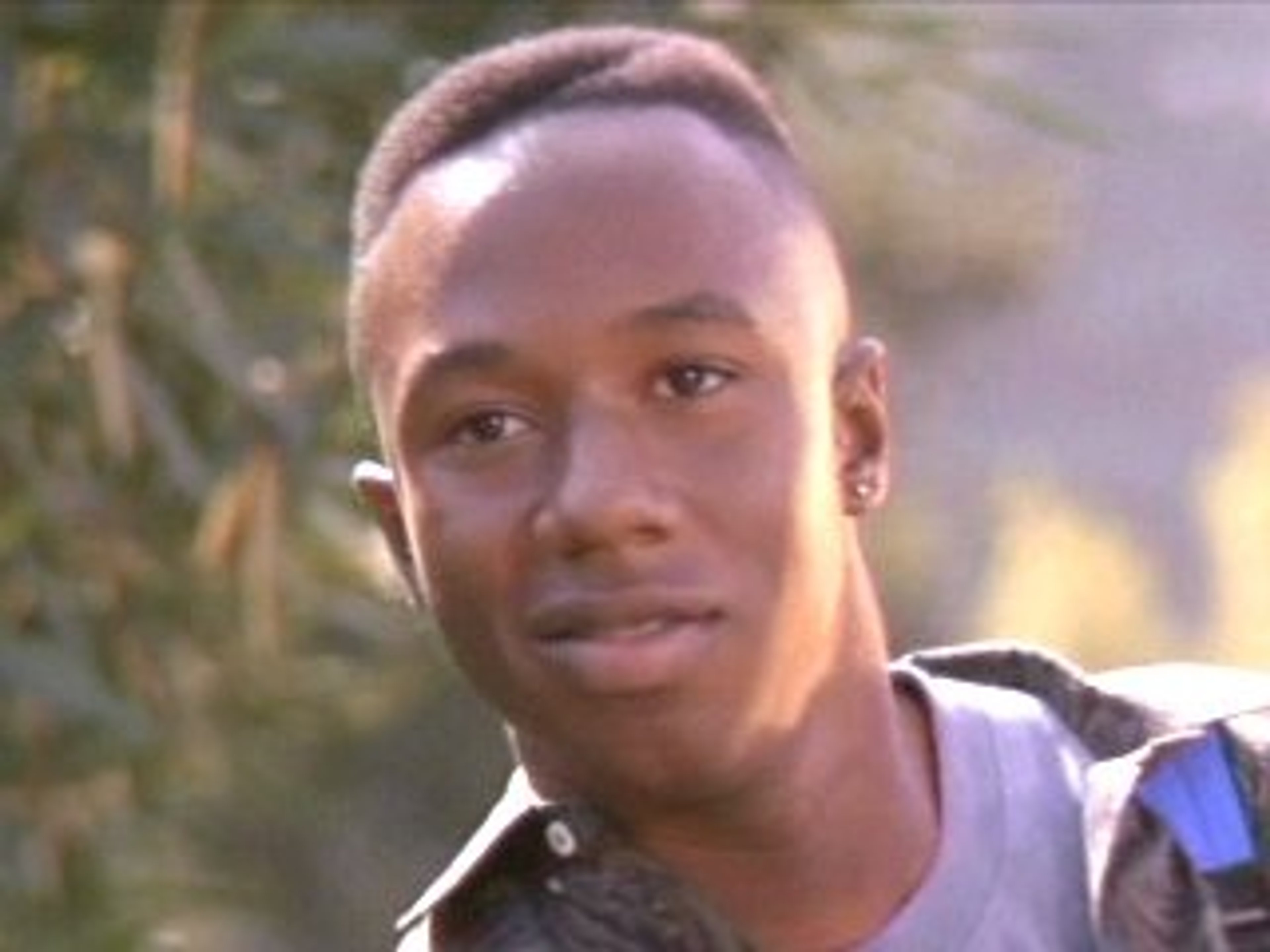 A young Black man with short dark hair wearing a t-shirt and jeans